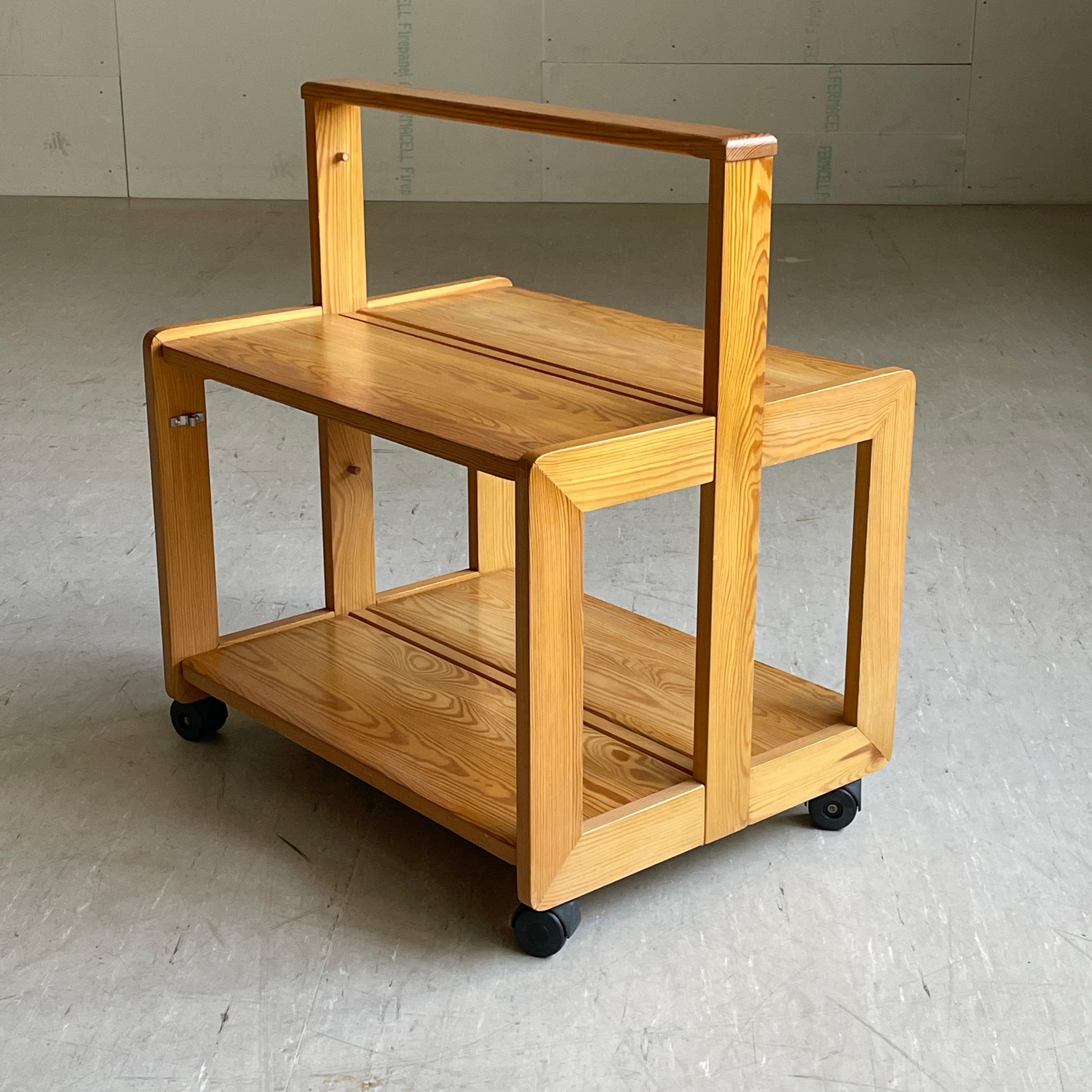 1970's Scandinavian pinewood folding serving trolley / drinks cart. Solid pinewood construction with folding tabletops. Perfect solution for storing away if space is limited with a folded depth of only 10 cm's.
In the style of Rainer Daumiller.
In