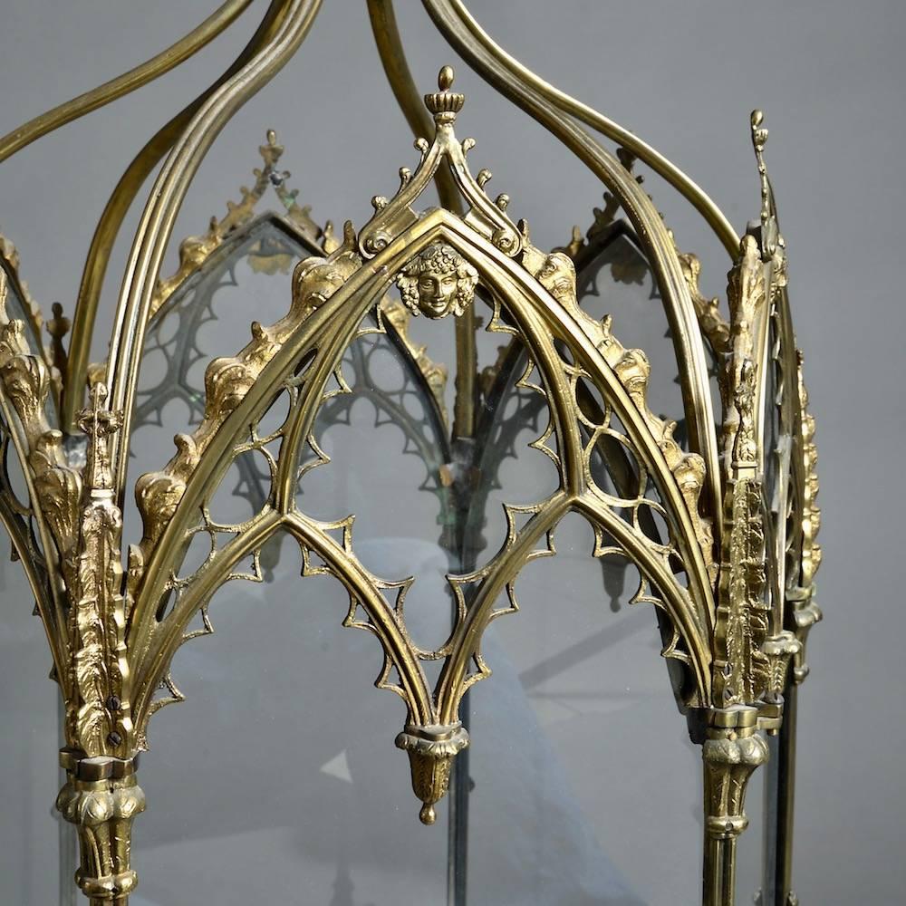 A fine Regency lacquered brass Gothic lantern, circa 1820.

Hexagonal, each glazed panel with Gothic tracery and a Bacchic mask flanked by spires.