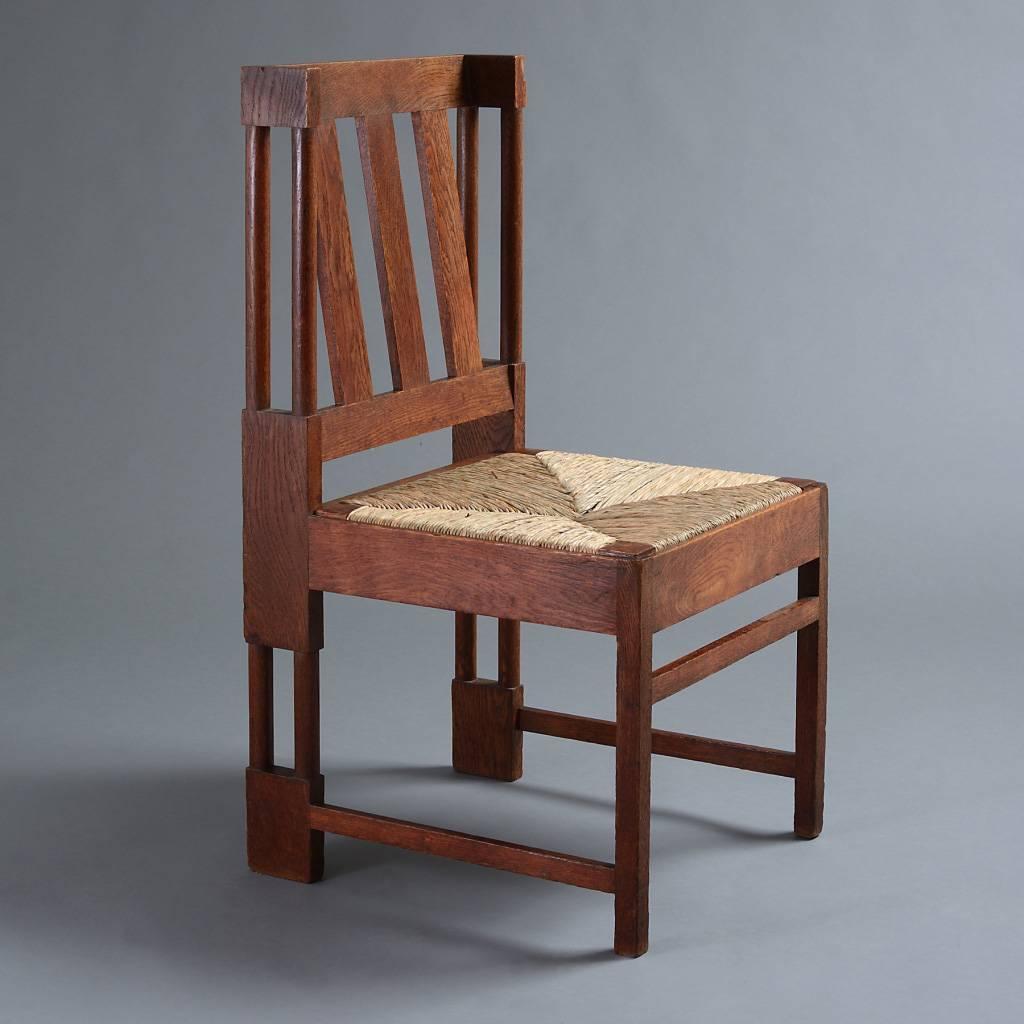 An unusual pair of Arts & Crafts oak chairs, circa 1910.