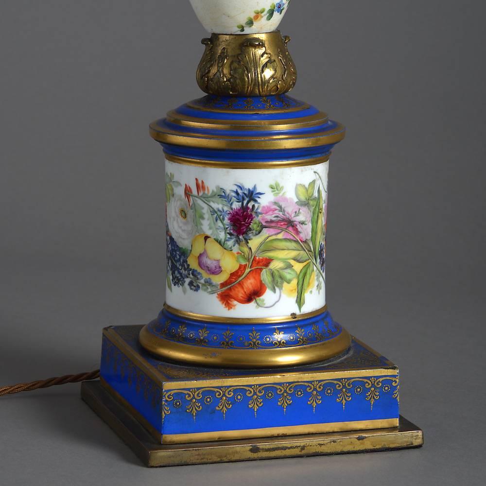 A fine pair of Paris ormolu-mounted porcelain lamps painted with flowers on a white ground, circa 1850.