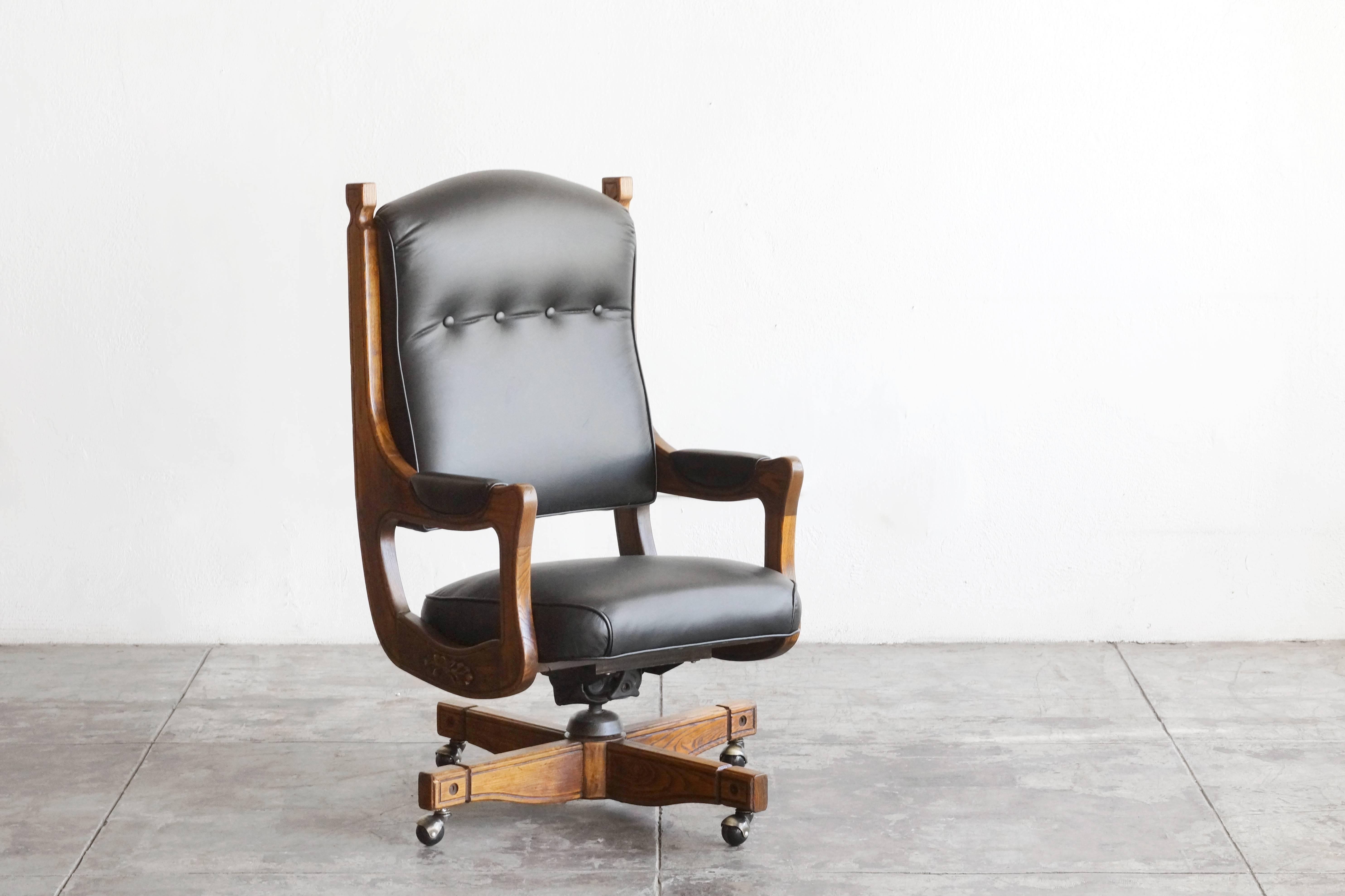 Impressive solid oak and tufted leather captains chair. Iconic Chesterfield style with solid oak 