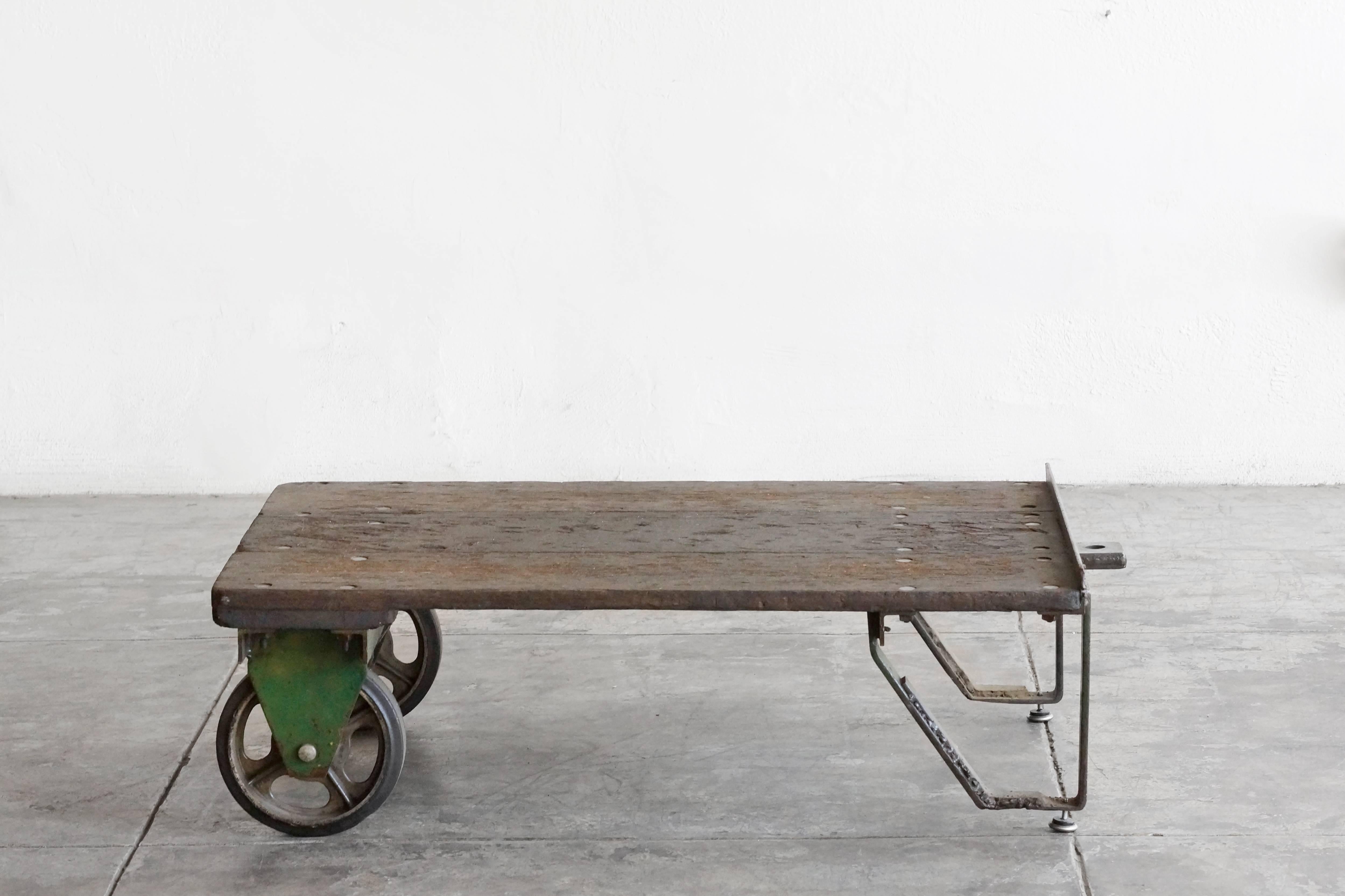 Vintage Industrial steel and wood cart suitable as low coffee table. Beautiful rustic wood and heavy-duty casters with excellent patina.

Dimensions: 36