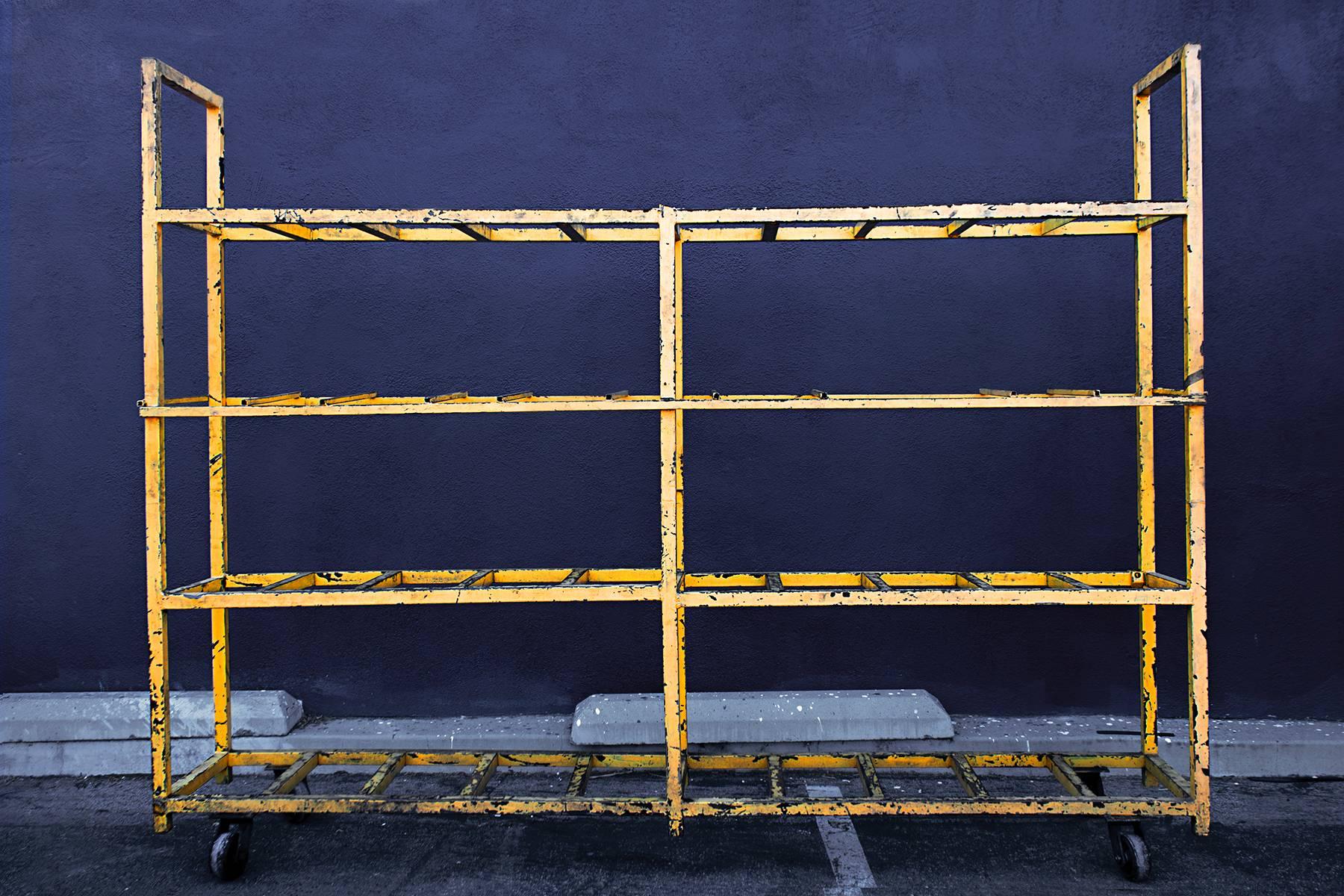 Large distressed yellow square tube rolling rack. Excellent for retail store display or industrial office environment. Originally served as a transmission rack in a repair shop. 

Dimensions:21