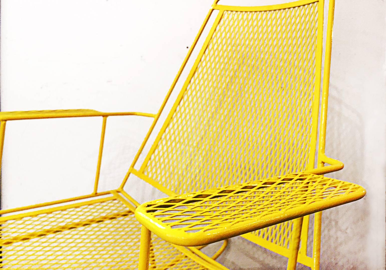 Fantastic expanded metal and solid bar rocking chair in the style of Russell Woodard. Streamline architectural design refinished in bright yellow powder-coat. Can be used indoor or outdoors. Dimensions: 34" D x 29" W x 36" H.