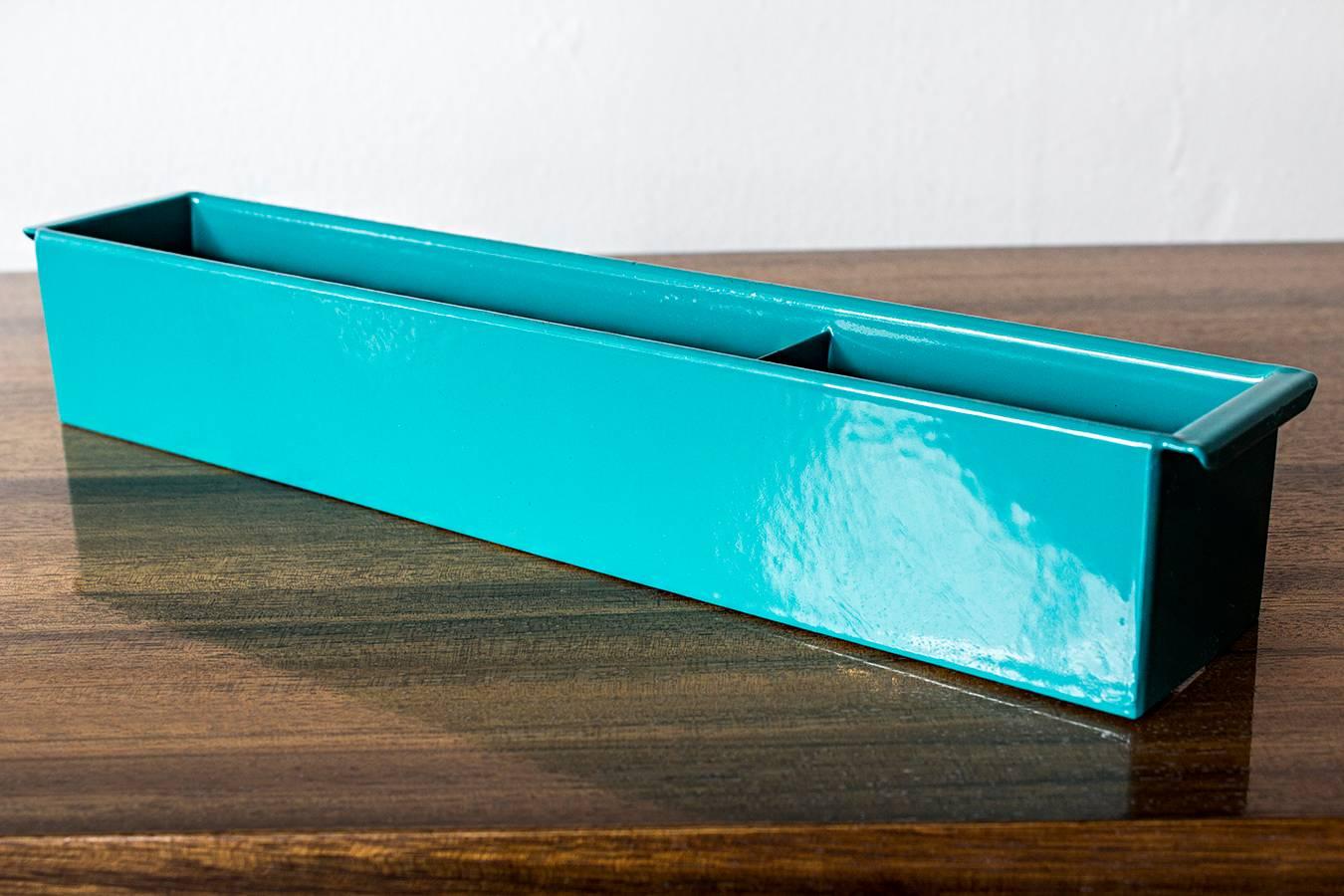 Once the insert to a classic tanker desk's utility drawer, we repurposed this neat industrial piece for use as a desktop organizer. Steel has been newly powder-coated in a pop of turquoise. Features four slots, ideal for storing coins, pens and