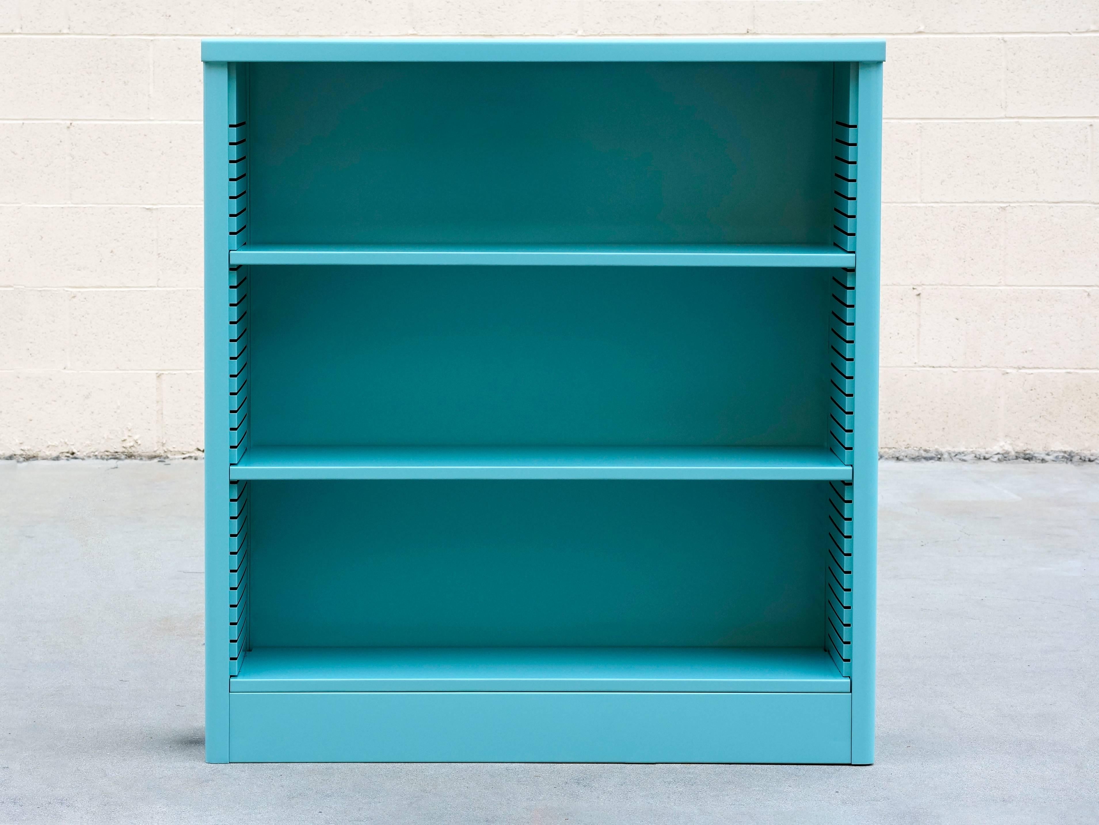 Neat 1960s tanker style steel bookcase freshly powder-coated in high gloss turquoise. Originally used in the UCLA math department, this adjustable three-shelf unit is an excellent storage option– its sleek and compact, yet holds many books. It's