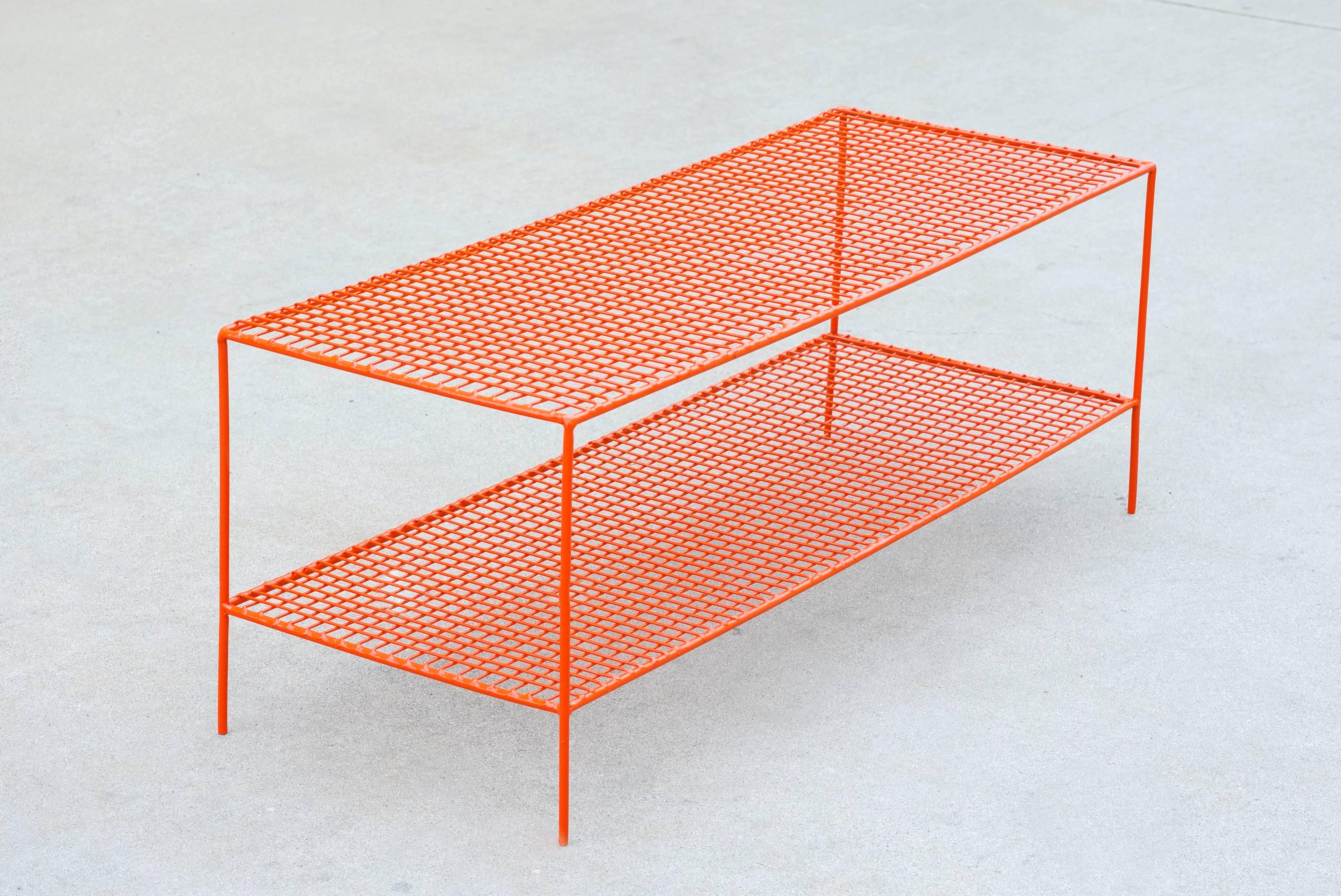 Our retro shoe rack has a modern flare with its grid shelf design. Composed of steel and refinished in high gloss orange powder coat. This modular piece is ideal for retail display or put it to use as a storage unit in your home. 

Dimensions: 14
