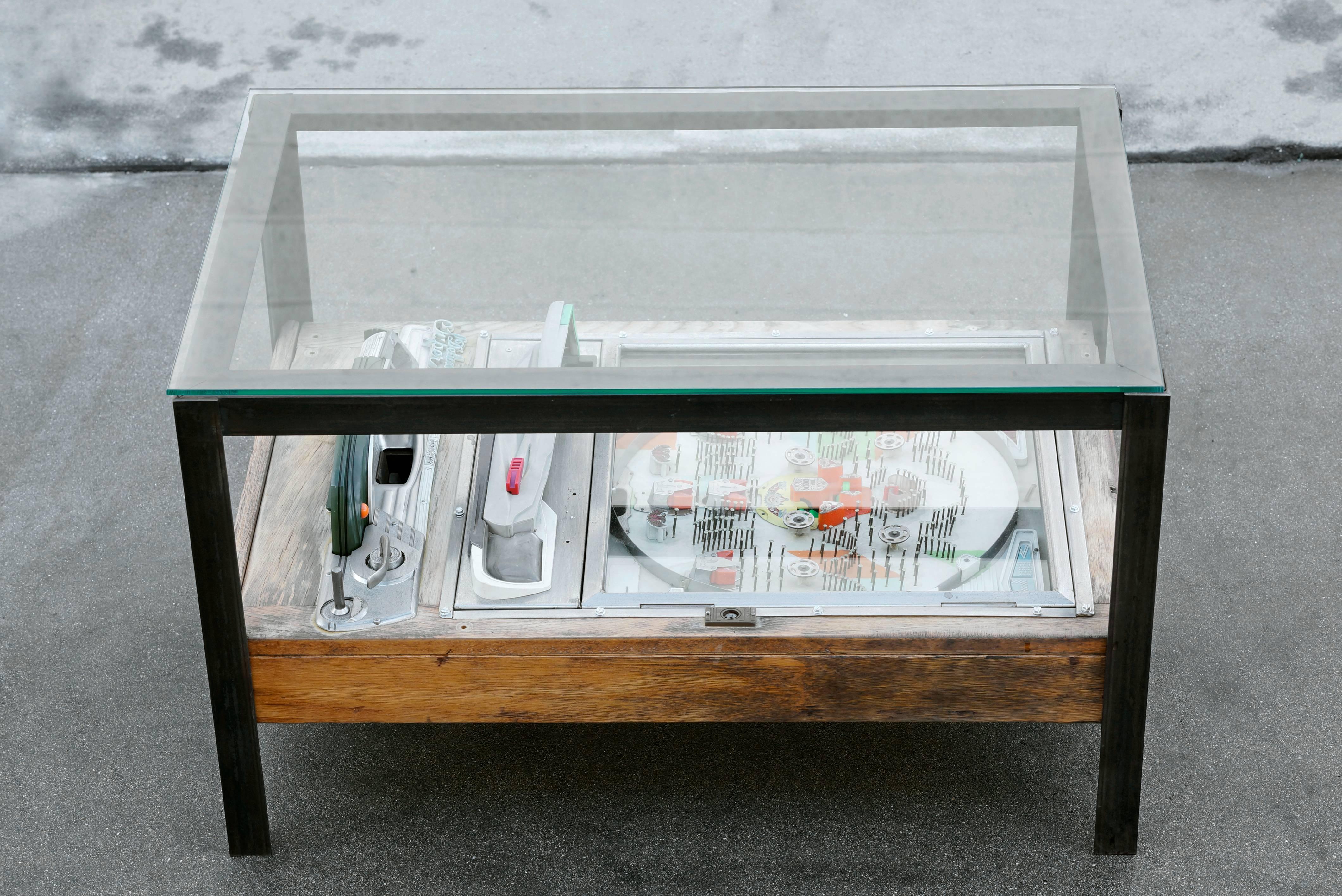 Our unique coffee table combines a vintage Japanese Pachinko arcade game in a custom-made steel frame with a tempered glass top. Pachinko is a mechanical game originating in Japan; like pinball machines, Pachinko boards have a fantastic retro vibe.