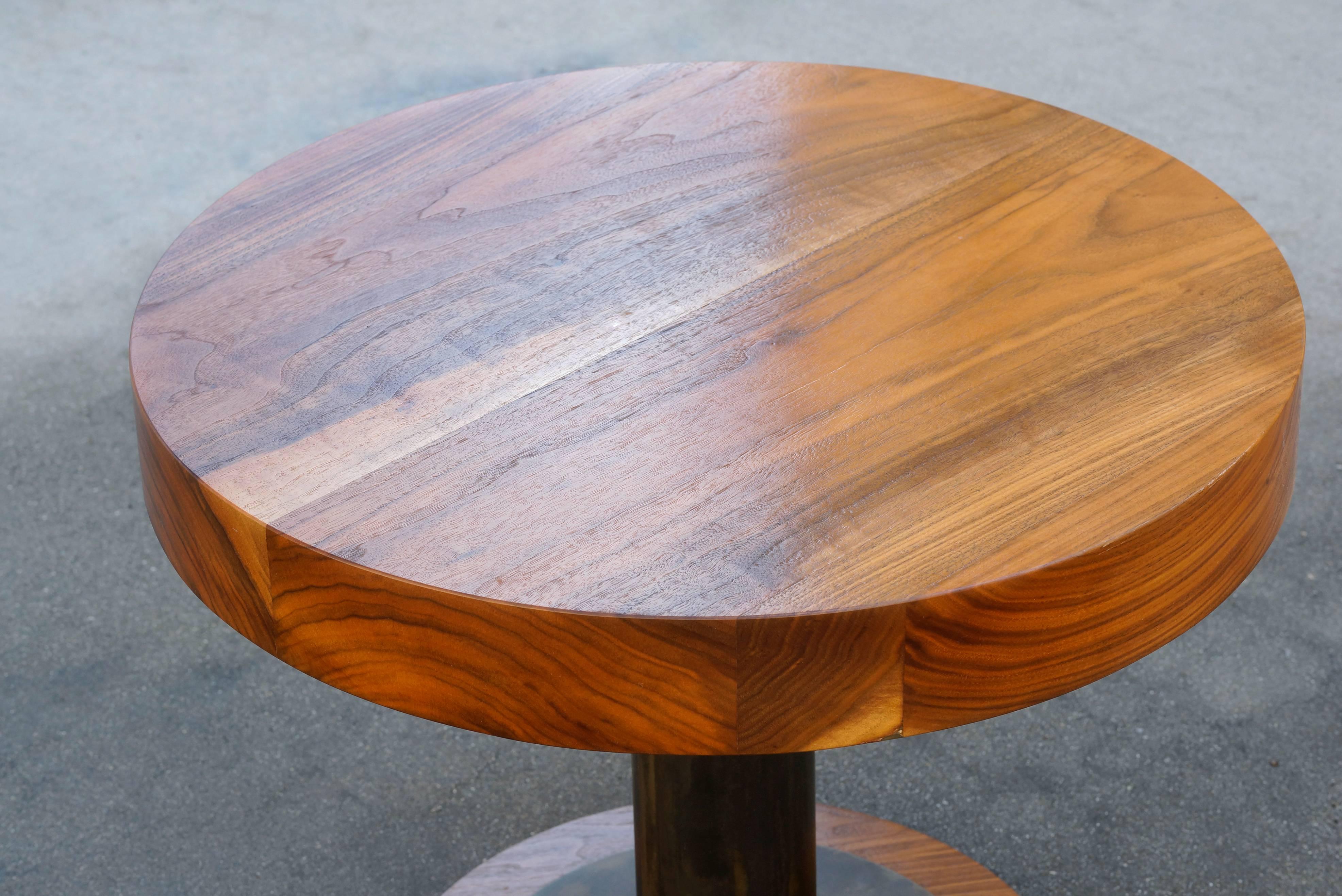 This gorgeous wood and steel table is composed of a lacquered 3