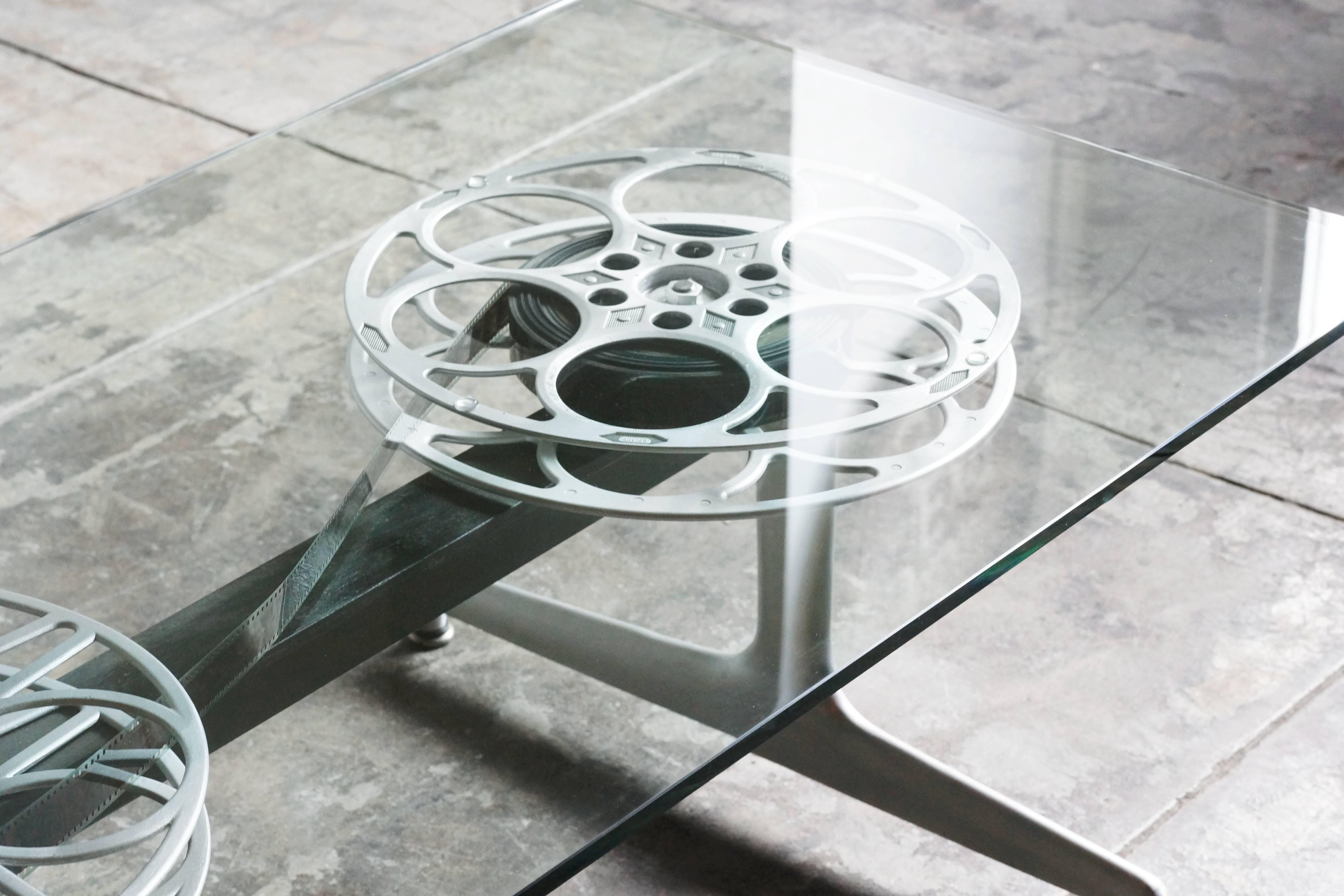 Back by popular demand! The Rehab vintage original film reel coffee table is a favorite of entertainment executives and film lovers alike. Made from vintage film reels and mid century aluminum bases, each configuration is unique based on