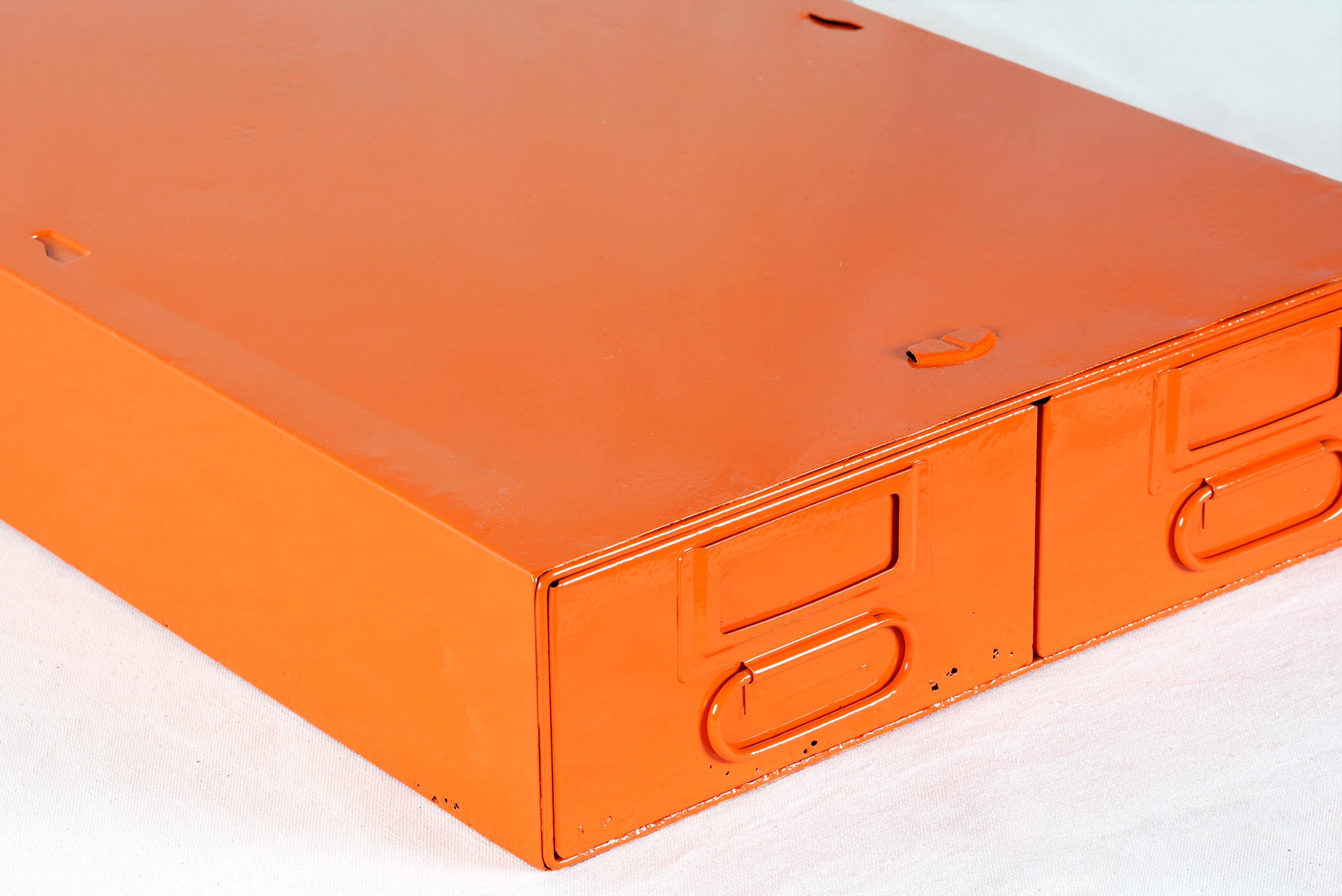 1940s card catalog filing unit with two deep, side by side pull-out drawers. Newly refinished steel in gloss tangerine powder coat (OG05). This heavy-duty organizational unit is perfect for storing anything from office supplies to recipe cards.