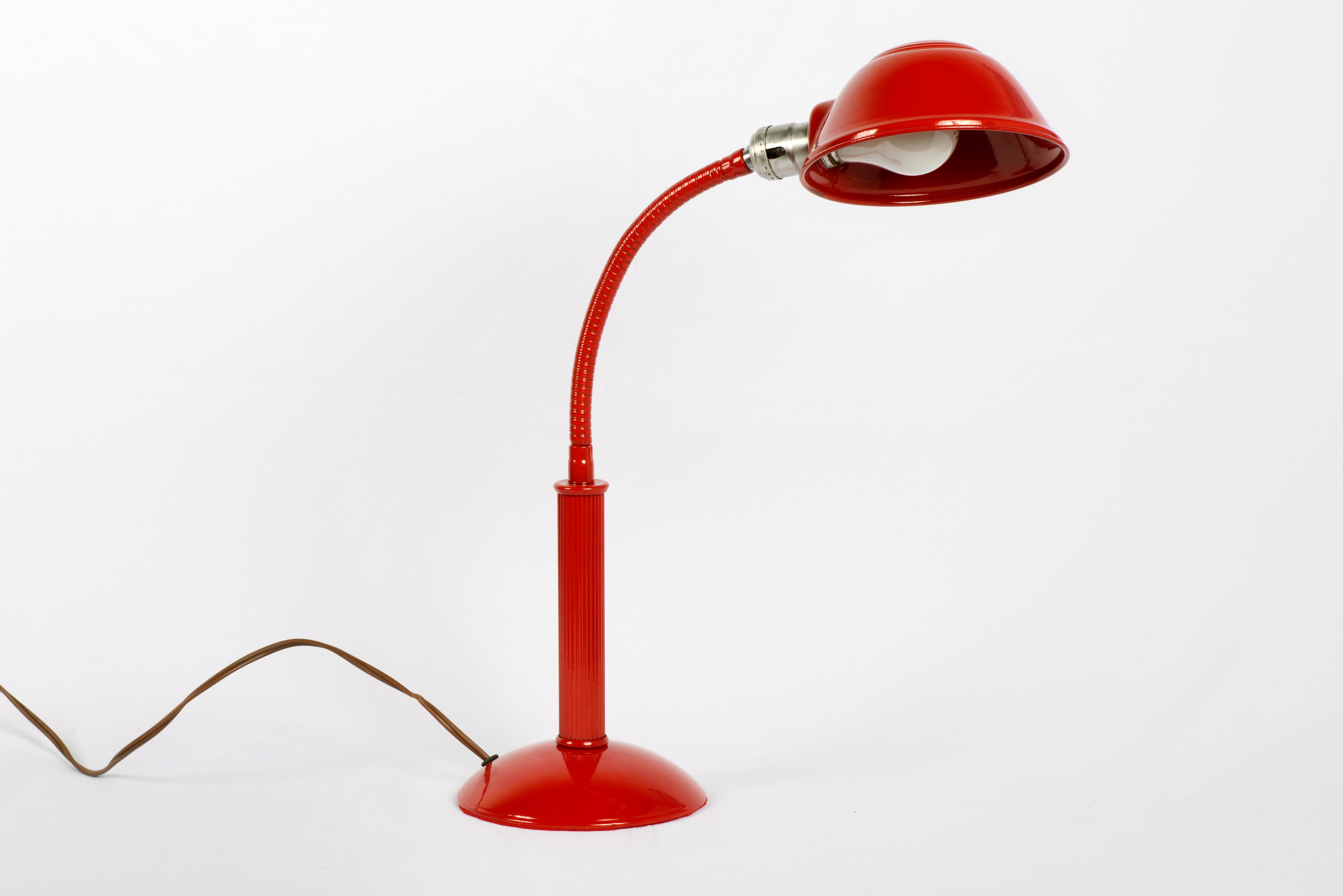 Put a little light on the subject with this fully functional retro gooseneck lamp from the 1960s. Refinished in a powder-coated pop of fire engine red (RD01), this totally unique accessory is sure to bring some cheer to your office space.