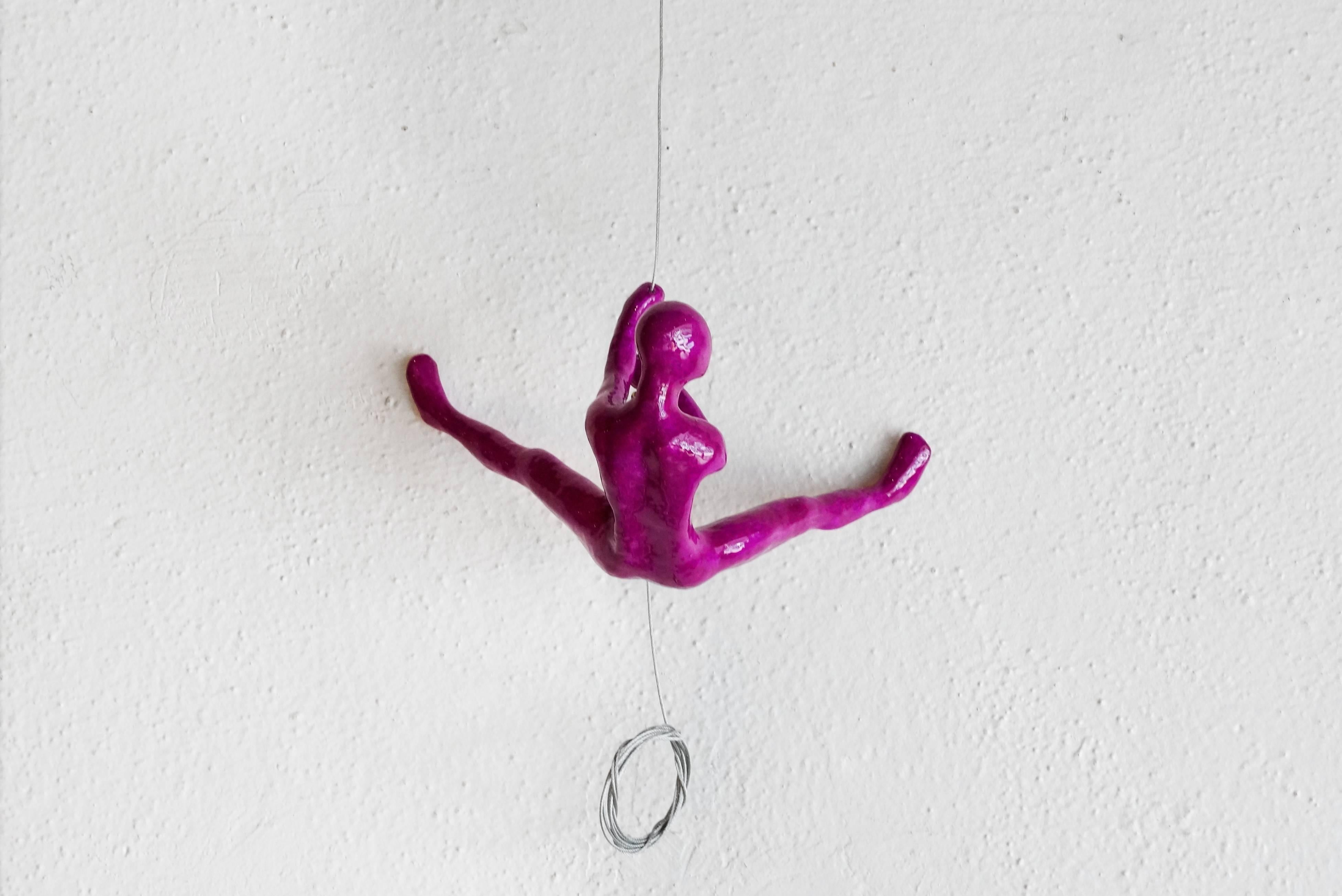 Wall Climber sculpture in magenta by artist Ancizar Marin (Colombian, b. 1968). Signed and dated. 

Additional Information
Marin makes colorful wall climber sculptures of ceramic, fiberglass and resin. Symbolic to rock climbers, they repel down