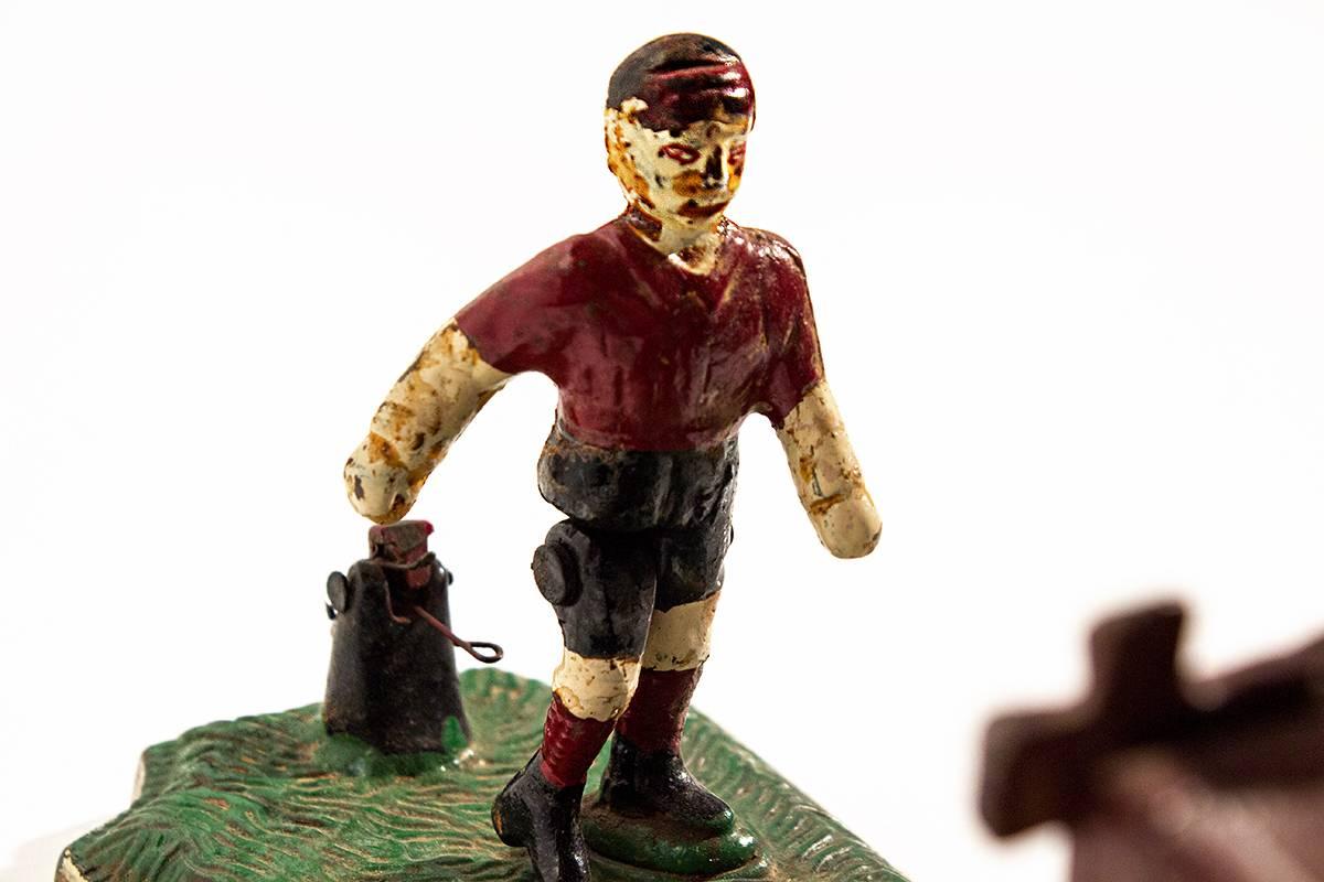 Late 19th century mechanical bank. Soccer player kicks the coin into the net by releasing the right leg. Great cast iron collectible.