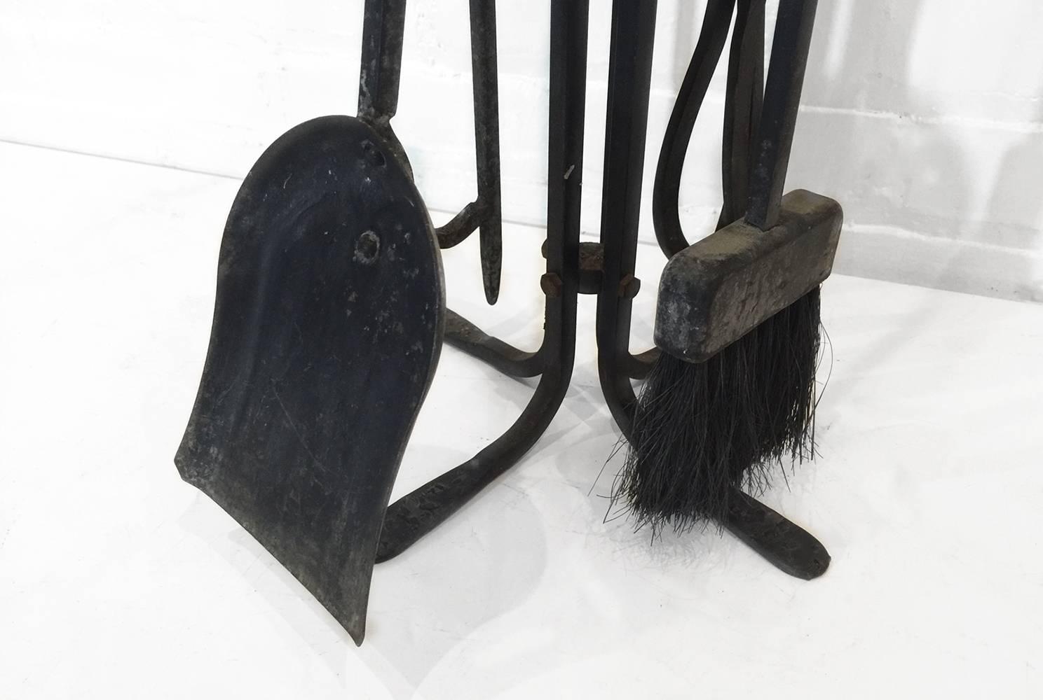 Hand-forged Mid-Century fireplace set includes brush, poker, shovel and tongs. 

Dimensions: 27.5