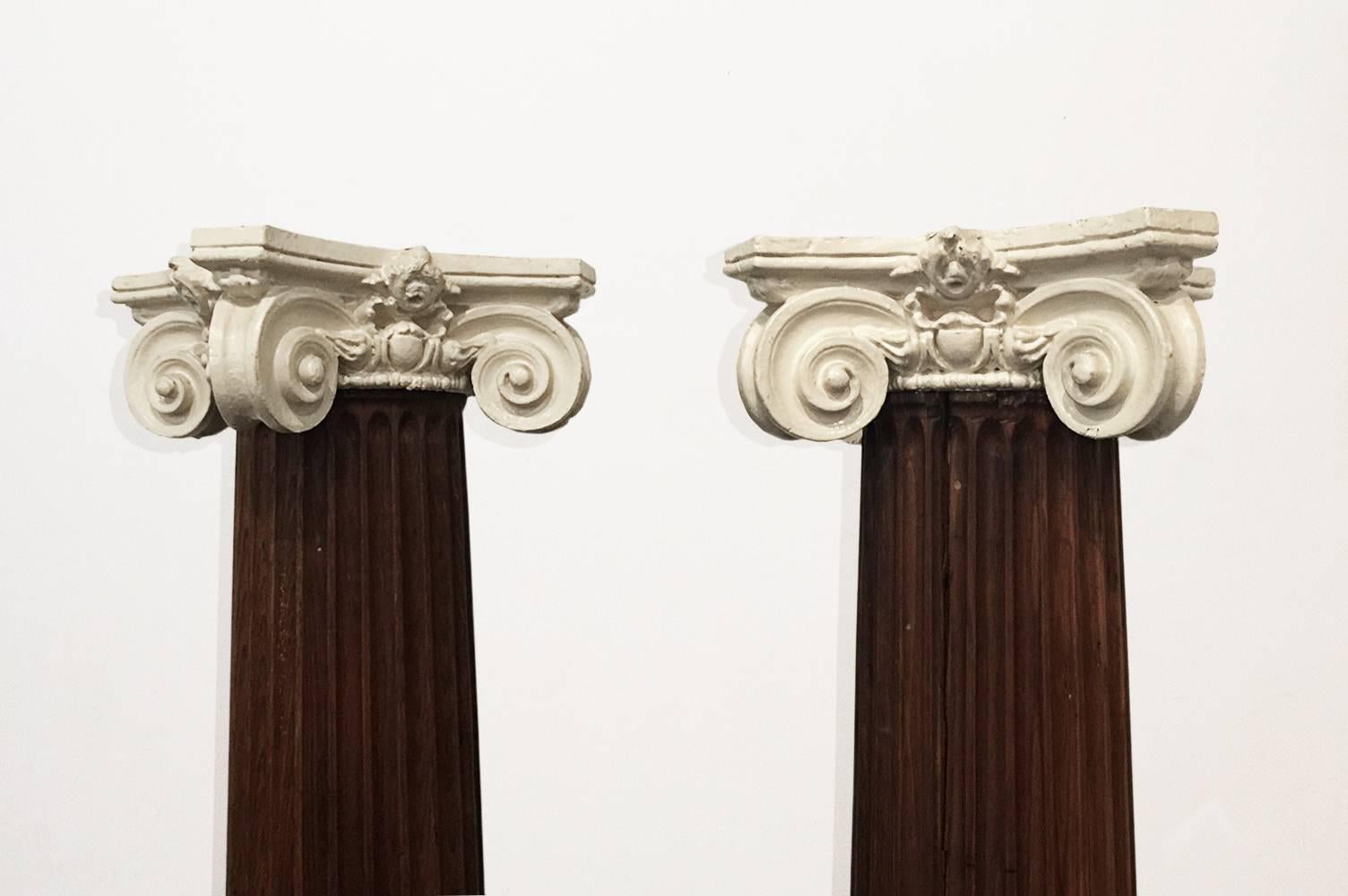 Awesome oak pillar with cast plaster Ionic style capital. Constructed from eight carved oak planks connected with dove tail joints. Interior is hollow with round insert in top to receive the capital. Stately piece for indoor or outdoor use. One