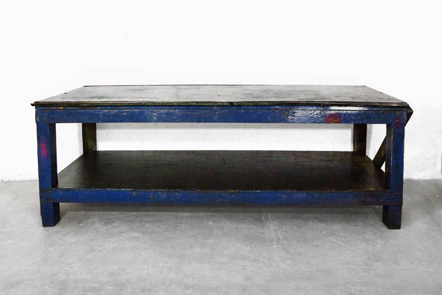 Killer 8 foot machine age workbench. Nicely distressed blue paint with galvanized metal top. This baby has been ridden hard and put up wet. Still solid as a rock. Great work table or merchandising display.

Dimensions: 32