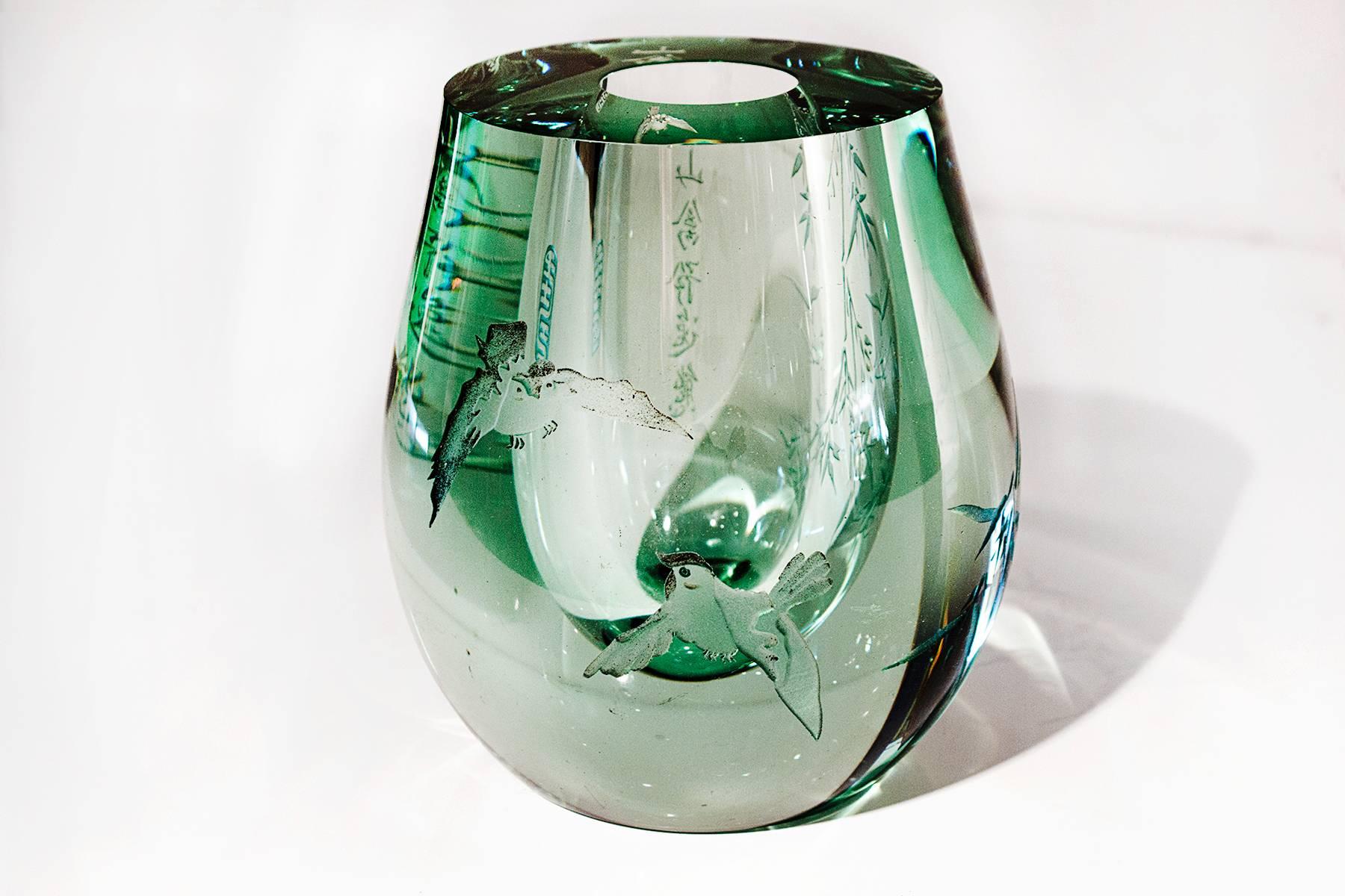 Super thick glass bud vase or candleholder with etched bamboo and bird motif. Etched characters and maker stamp on sides. Clear and subtle bluish green hue. A must have for the avid art glass collector. 

 Measures: 4.5