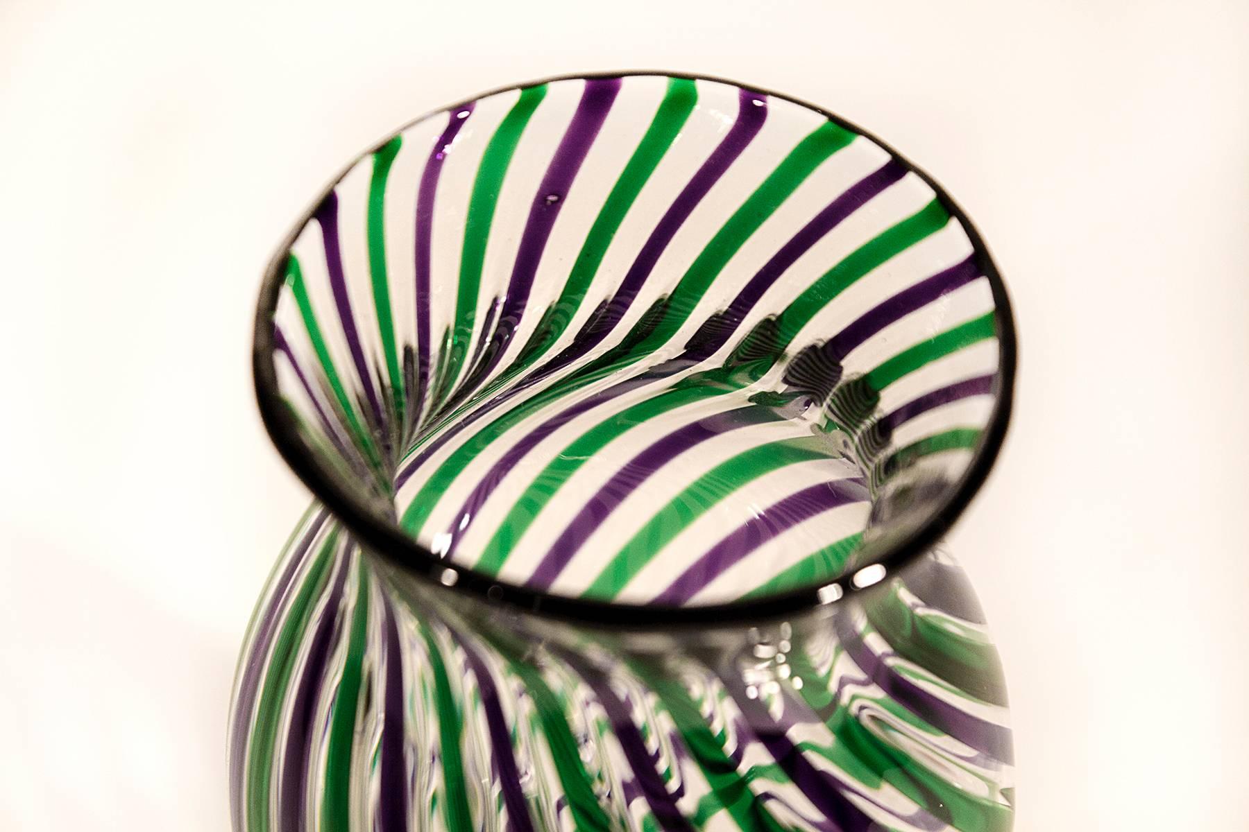 High quality green and purple ribbon fluted vase. Smooth around outside base and slightly textured along stripes at top. Thin glass is expertly crafted. A must have for any serious art glass collector. Illegible signature. Date 2010. 
Measures: 3