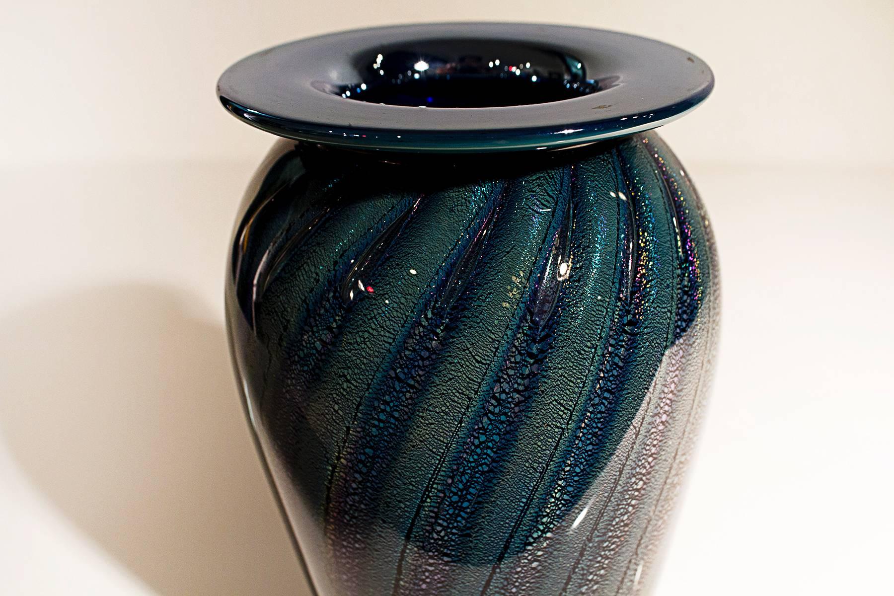 High quality Robert Eickolt iridescent greyish blue and black vase with flange rim. Twisting ribbon design with 