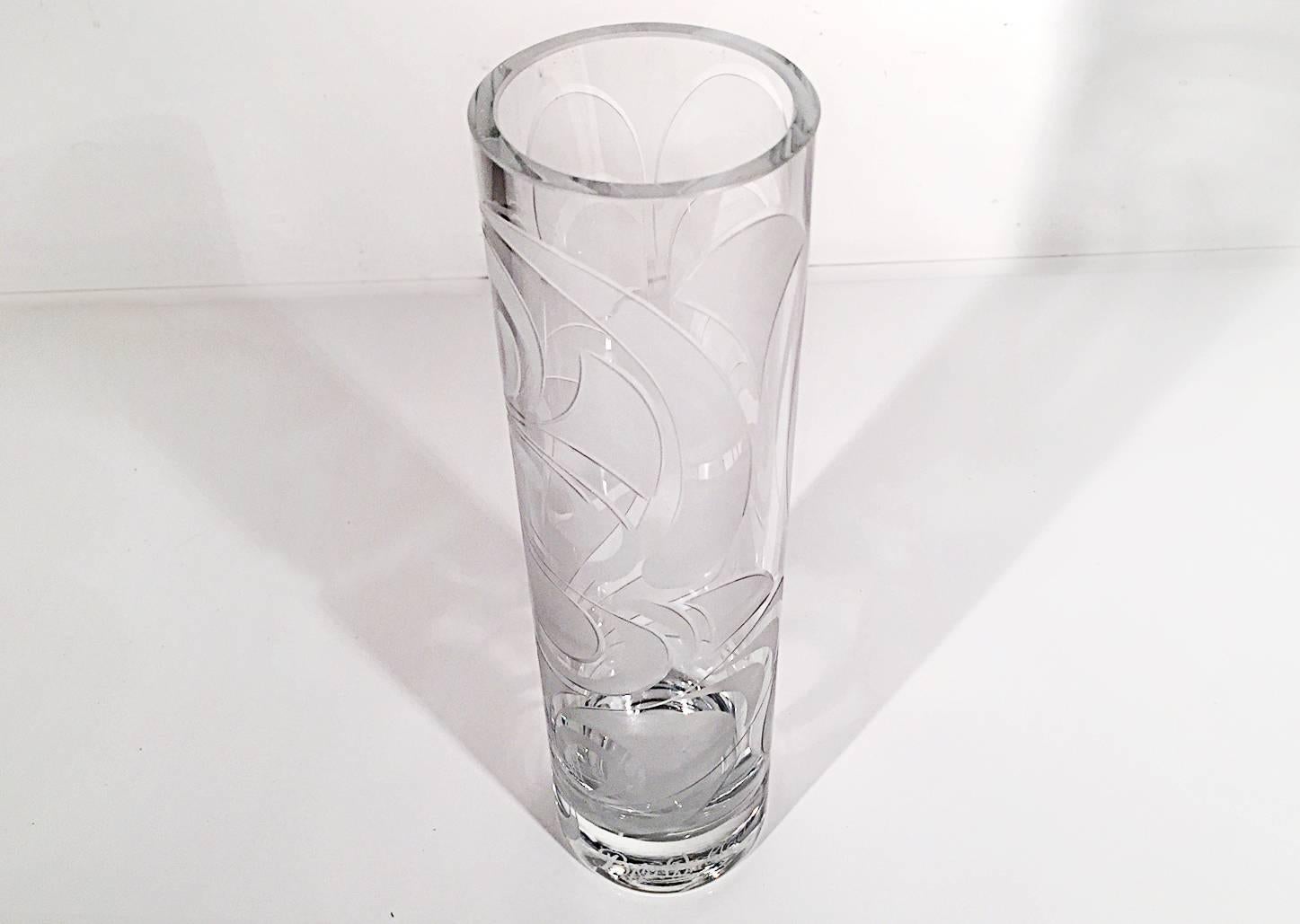 Tall and slender vase etched with a playful swirl pattern. Etched signature on bottom side. 
Measures:
2.5