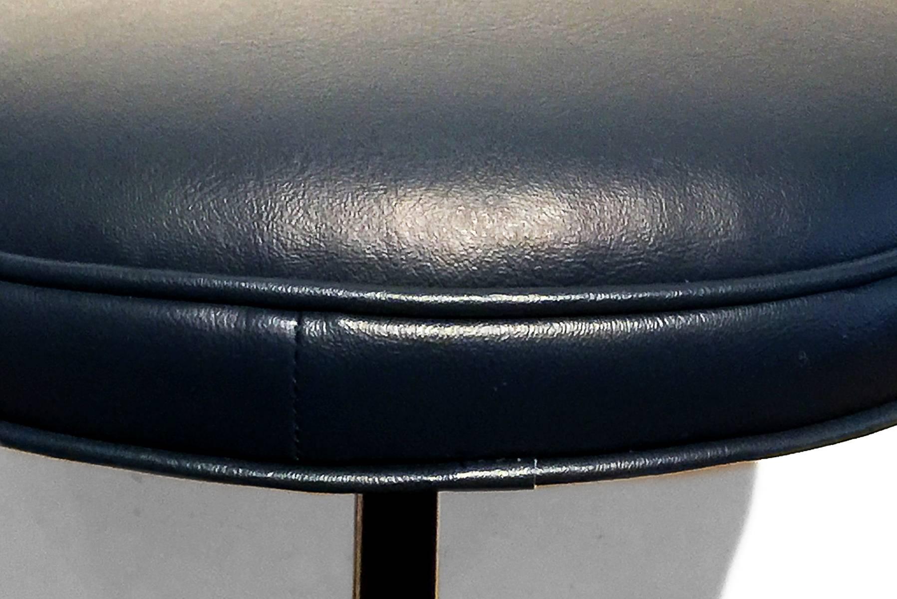 Fixed height counter stool refinished in dark blue powder coat and dark blue vinyl. Dimensions: 15.5" diameter x 18.5" height.