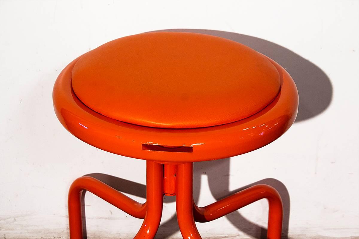 Vintage drafting stool refinished in electric orange powder coat. Measure: 16 1/2" fixed seat height,

14.5" diameter x 16.5" height.