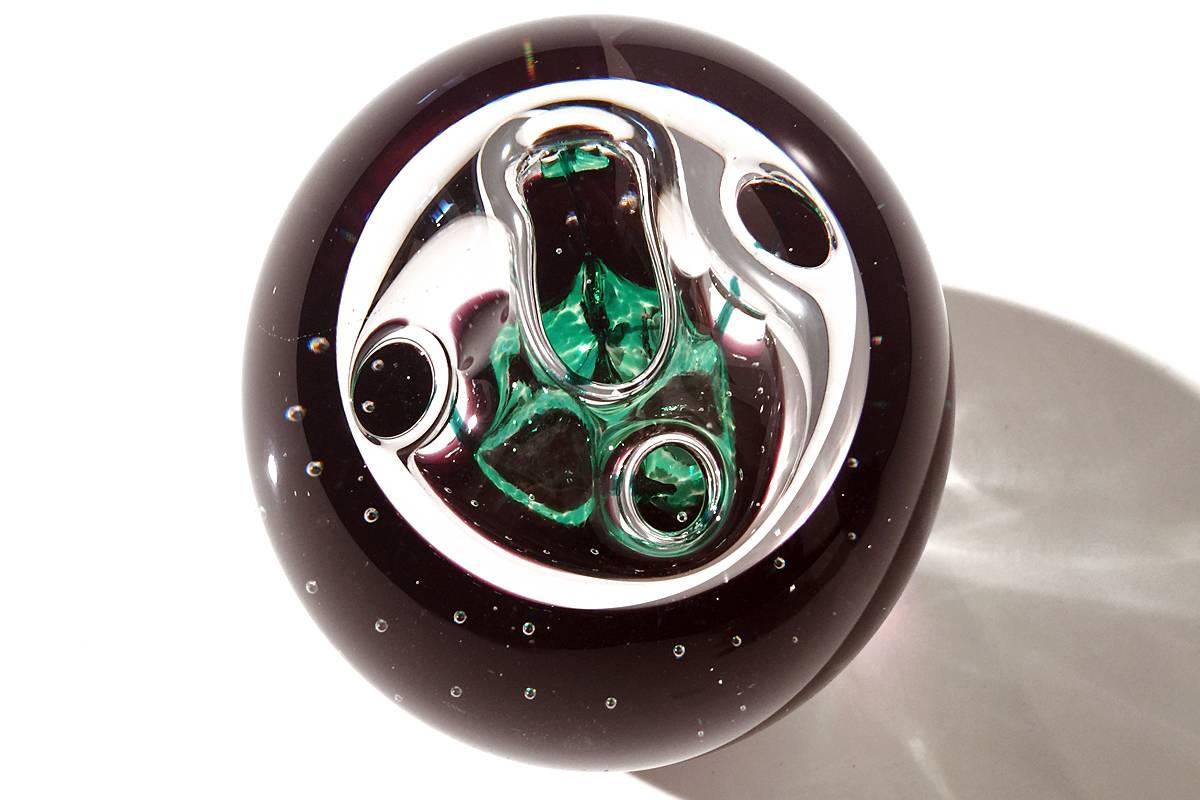 Beautiful paperweight from Scottish glass studio Caihtness. Dark plum base with green and clear 