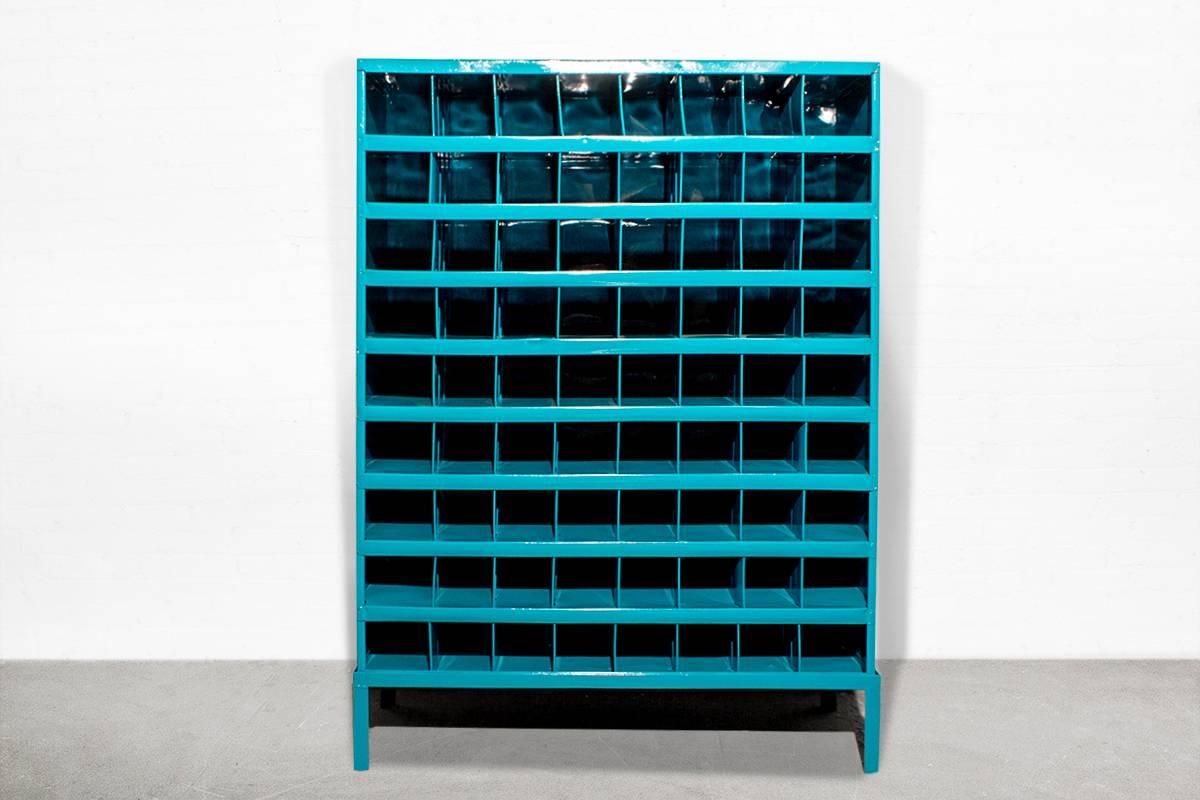 A square tube steel base has been added to this 72 compartment Industrial storage unit to create the perfect wine rack. Each bottle fits perfectly into the cubby for handy wine storage. Refinished in powder coat turquoise. 

Dimensions: 12" D