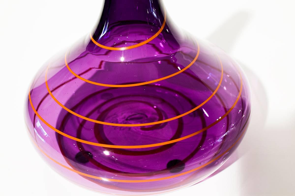 Superb squat bud vase by Avidan Ross. Beautiful transparent purple with an orange stripe swirl and elongated neck. Signed on bottom: Avidan

Measures: 6.5