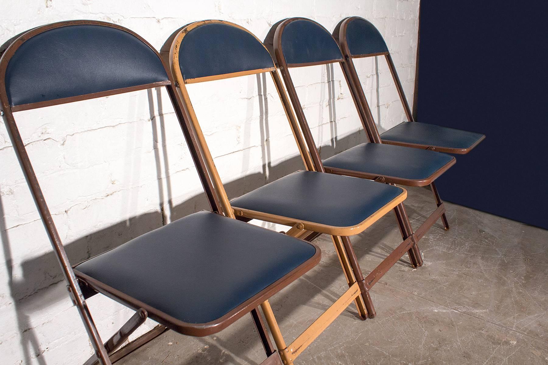 Retro set of metal folding chairs newly refinished in high-quality navy blue vinyl. Original brown metal frames. High back styling. 

Dimensions: 14.5