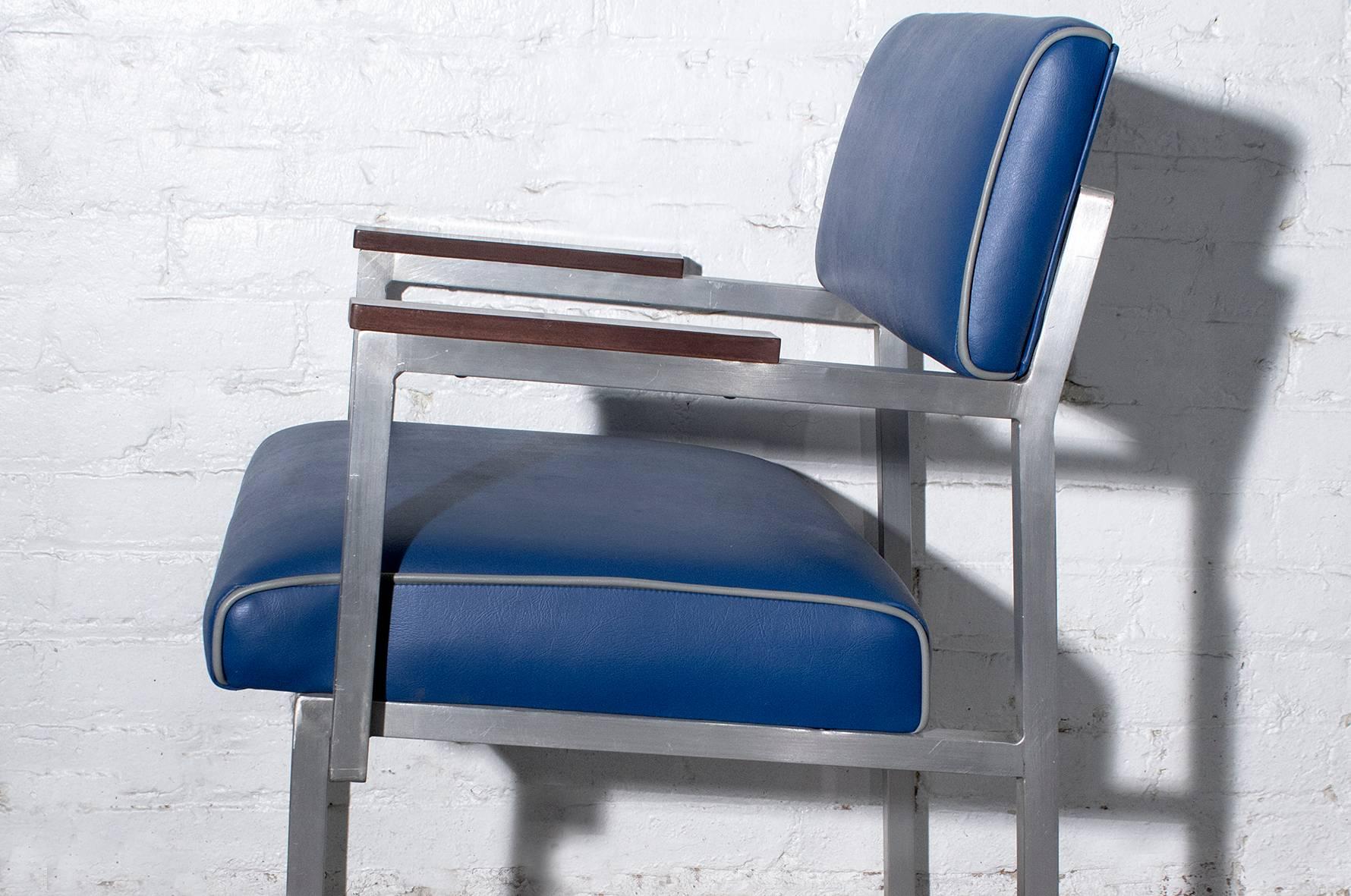Excellent cole steel armchair with unusual modern Industrial styling. Composed of aluminium square tubing and wood arms. We reupholstered this beauty in high-quality blue vinyl with grey pipping.
