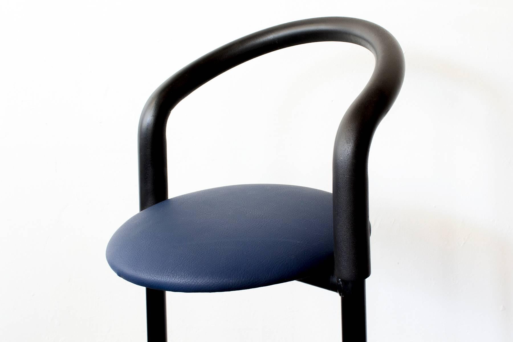 This vintage stool features bold geometric shapes and a tubular steel frame, reminiscent of celebrated 1980s Memphis Group designs from Italy. We updated this graphic piece with a newly reupholstered seat in pebbled blue vinyl. 

Dimensions: 20