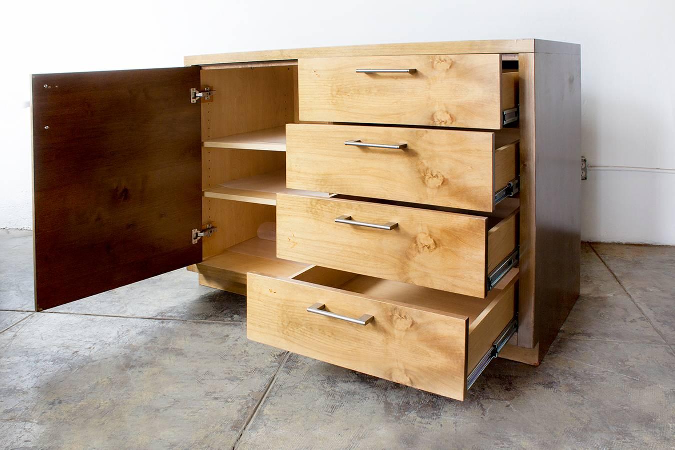 Handmade of solid maple, this lovely (and quite heavy) storage piece is ideal for use as a dresser, credenza or sideboard. Beautiful craftsman throughout including glider drawers and brass hardware. Features four drawers and a three shelf cabinet,