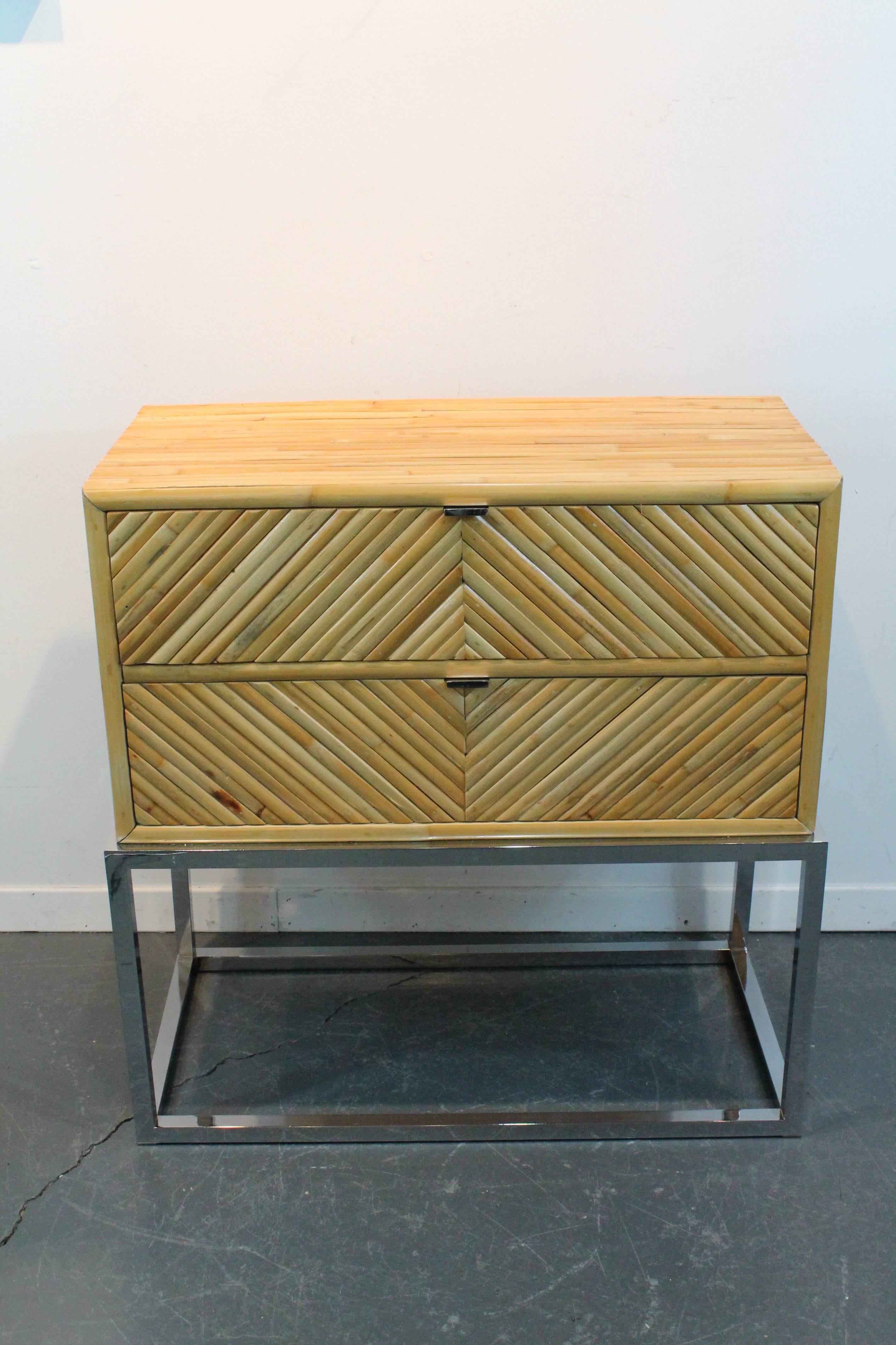 Great organic Modernist two drawered split bamboo cabinet designed by Milo Baughman can be used as an end table or a nightstand. Set on a chromed steel base. In remarkable condition.