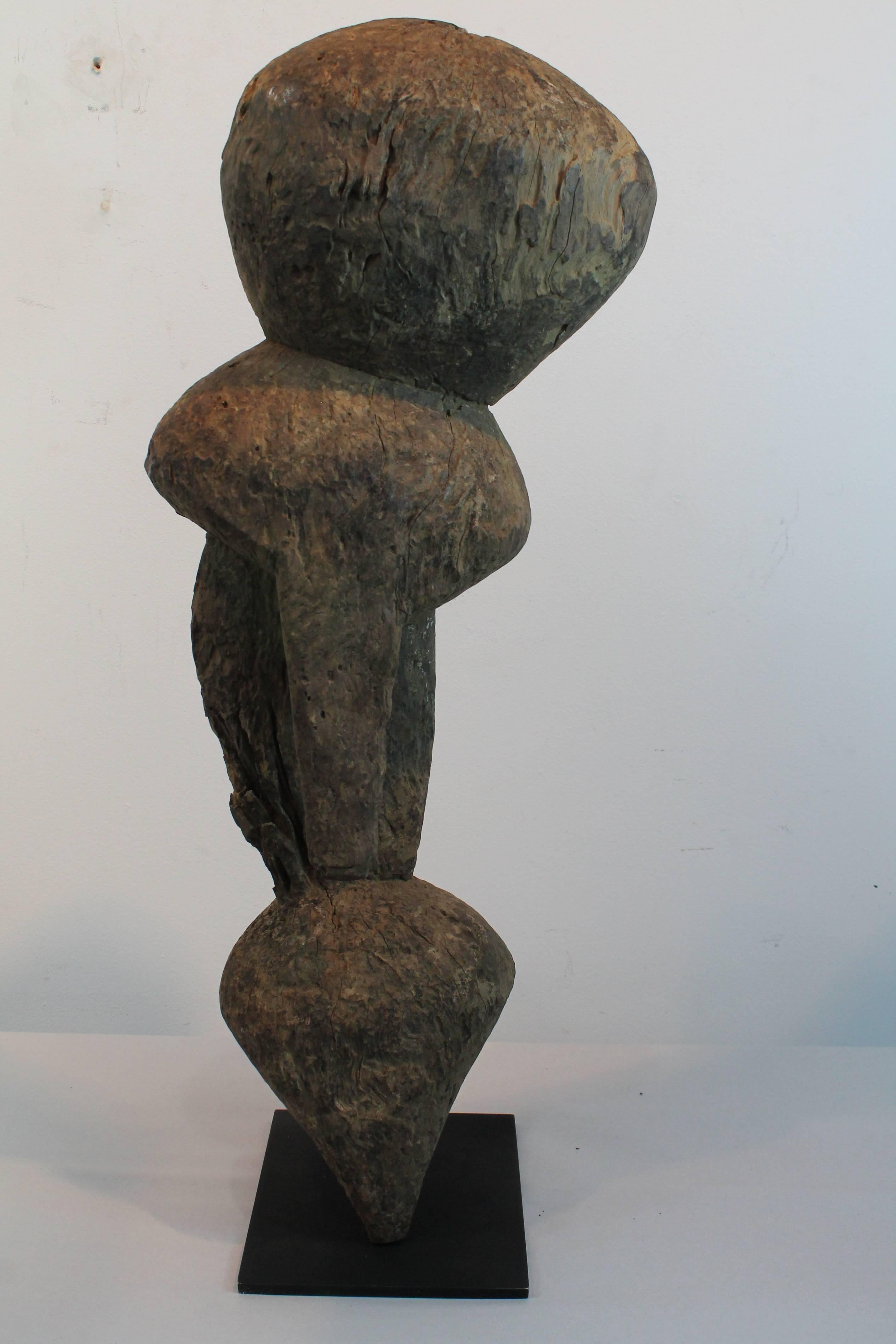 This evocative and powerfully Minimalist and primitive form is a Moba shrine/protective figure. These figures are known as Tchitcheri Sakwa, and stand as sentinels in front of Togo homes and village entrances, and are also placed on family altars,