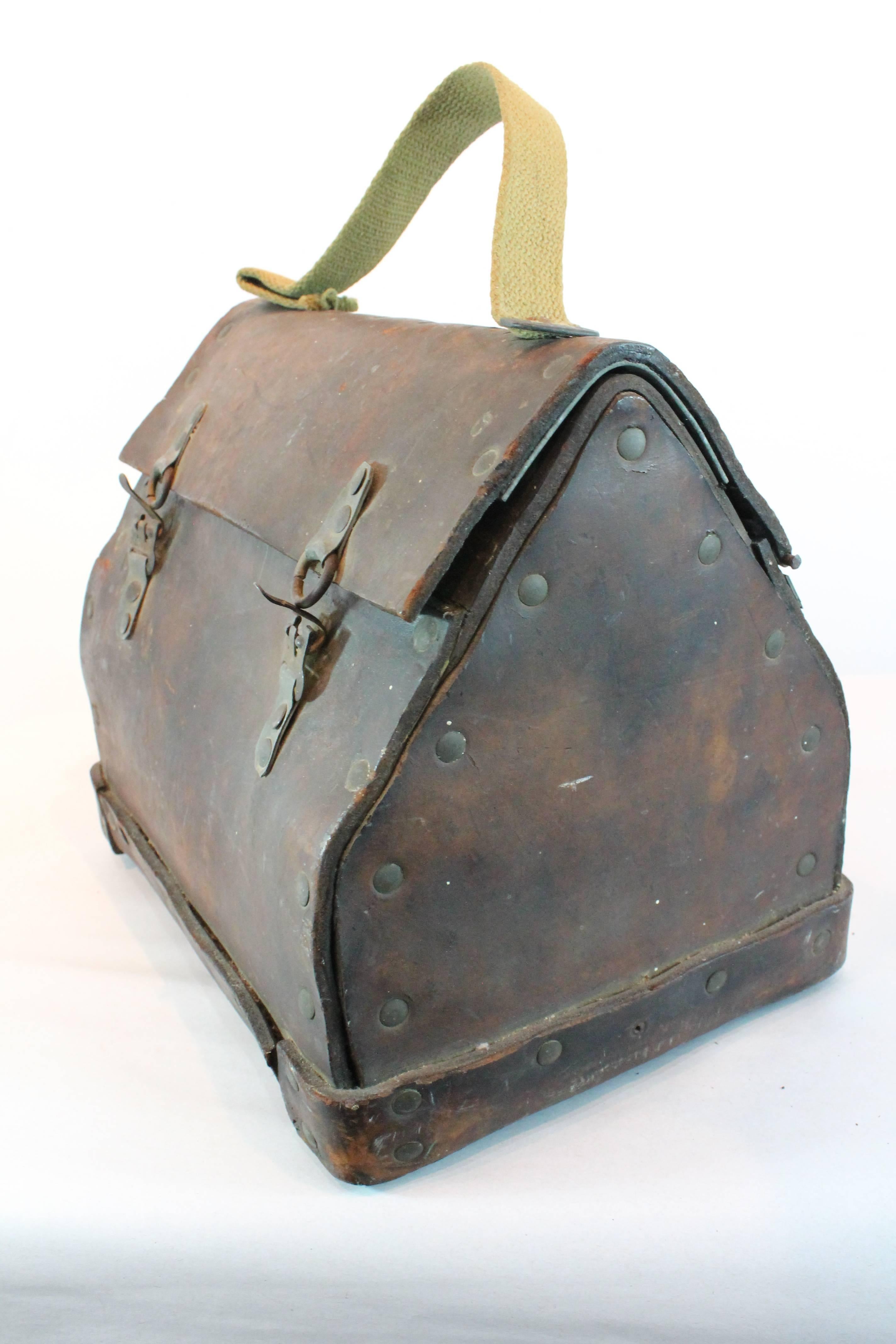Wonderful primitive construction on this Folk Art handmade thick leather lunch box.
Tremendous patina and surface.
We are not certain if the original handle was also leather and the current handle replaced it long ago.