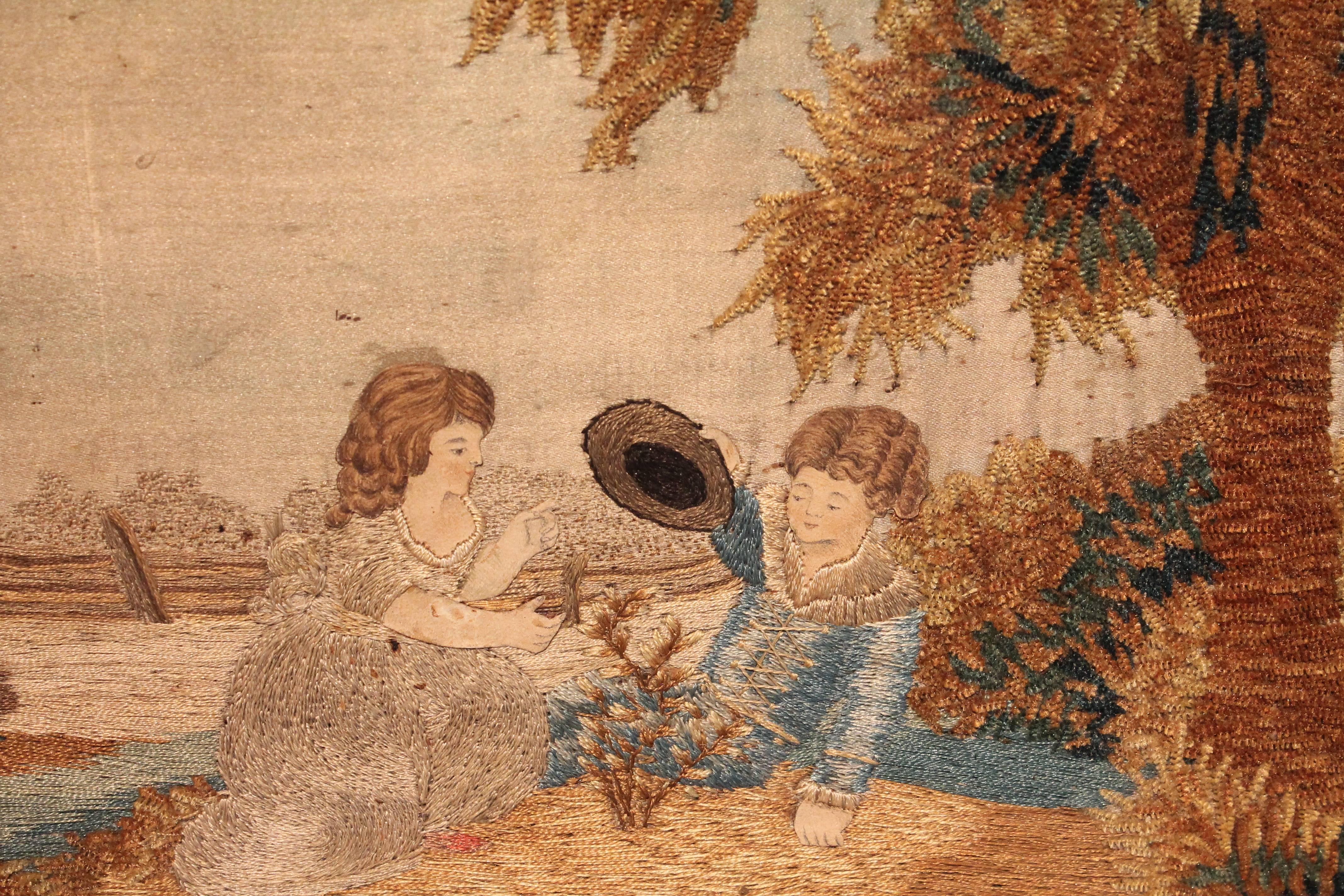 Exceptional detailing in this silk panel embroidered needlepoint country scene with two children playing under a tree in a beautifully executed landscape.
Great dimension on the leaves of the tree and a very strong graphic fence design. A very