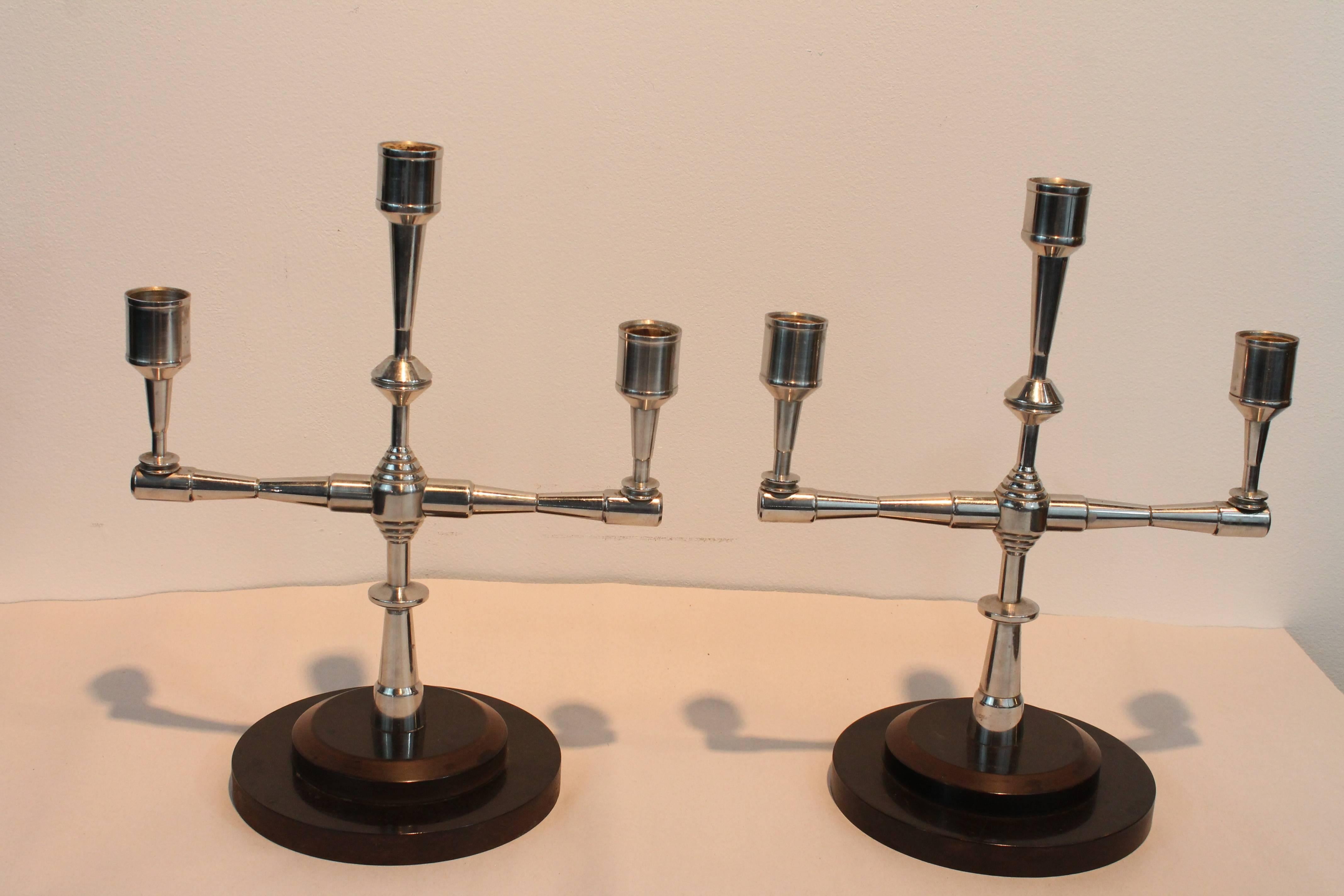 Exceptional Art Deco machinist turned chrome sculptural candle stands on bakelite plinths.
Outstanding graphic presence.