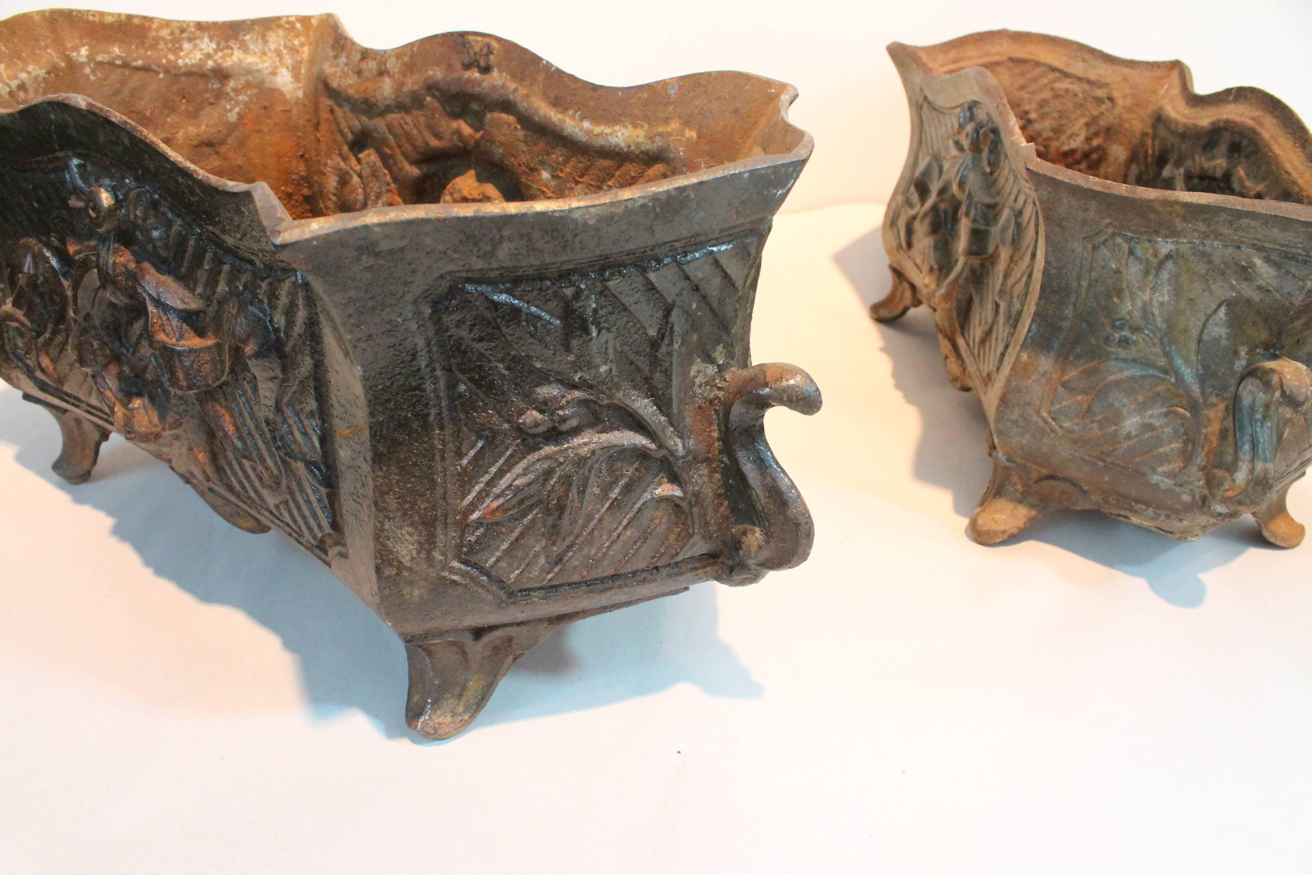 Fantastic detail in this pair of 19th cast iron French wreath detailed planters.
Great patina and fantastic form. One planter is slightly larger than the other, dimensions listed are for the larger.