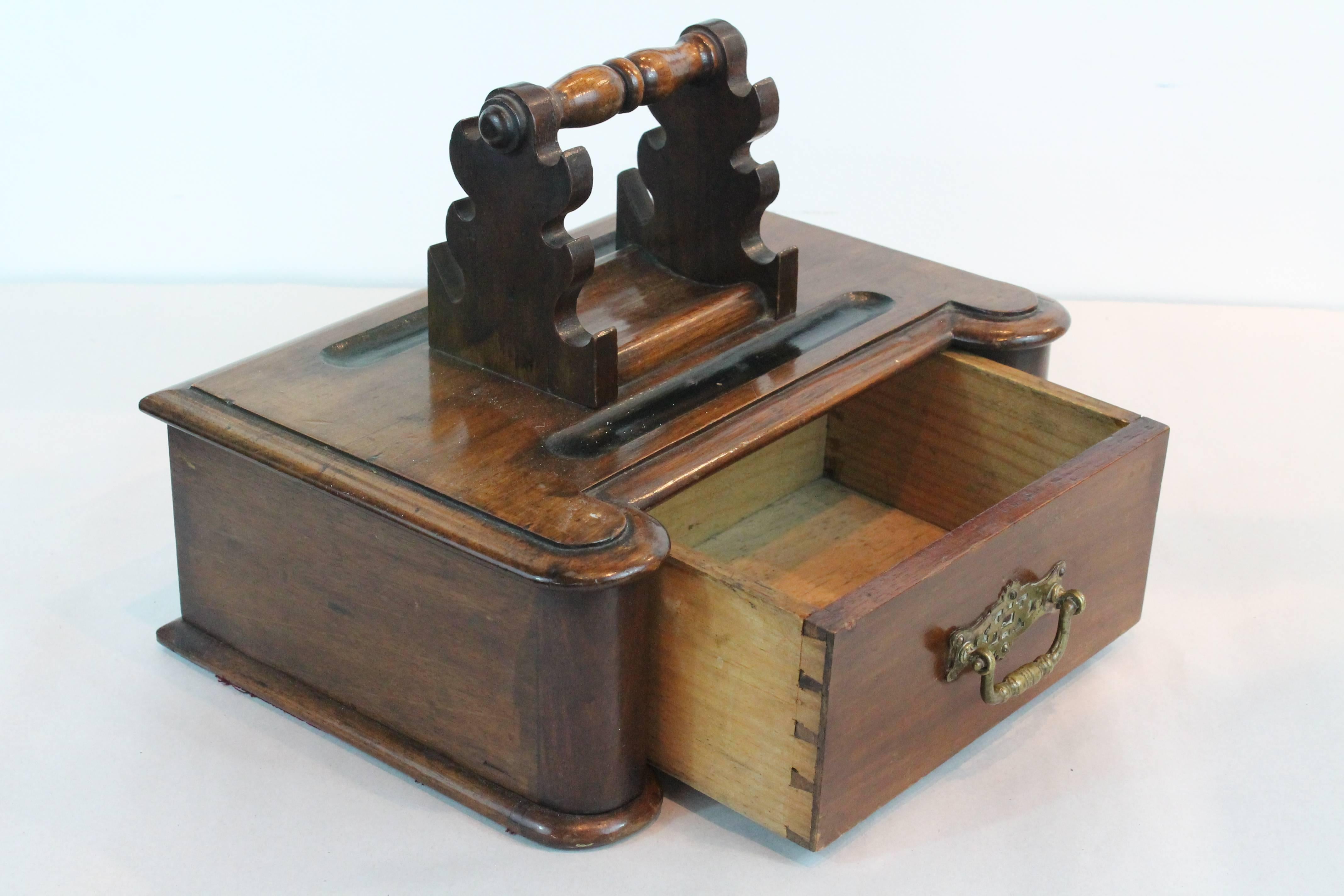 19th century carved walnut pen rest carrying stand.
Brass handled dovetailed drawer.

