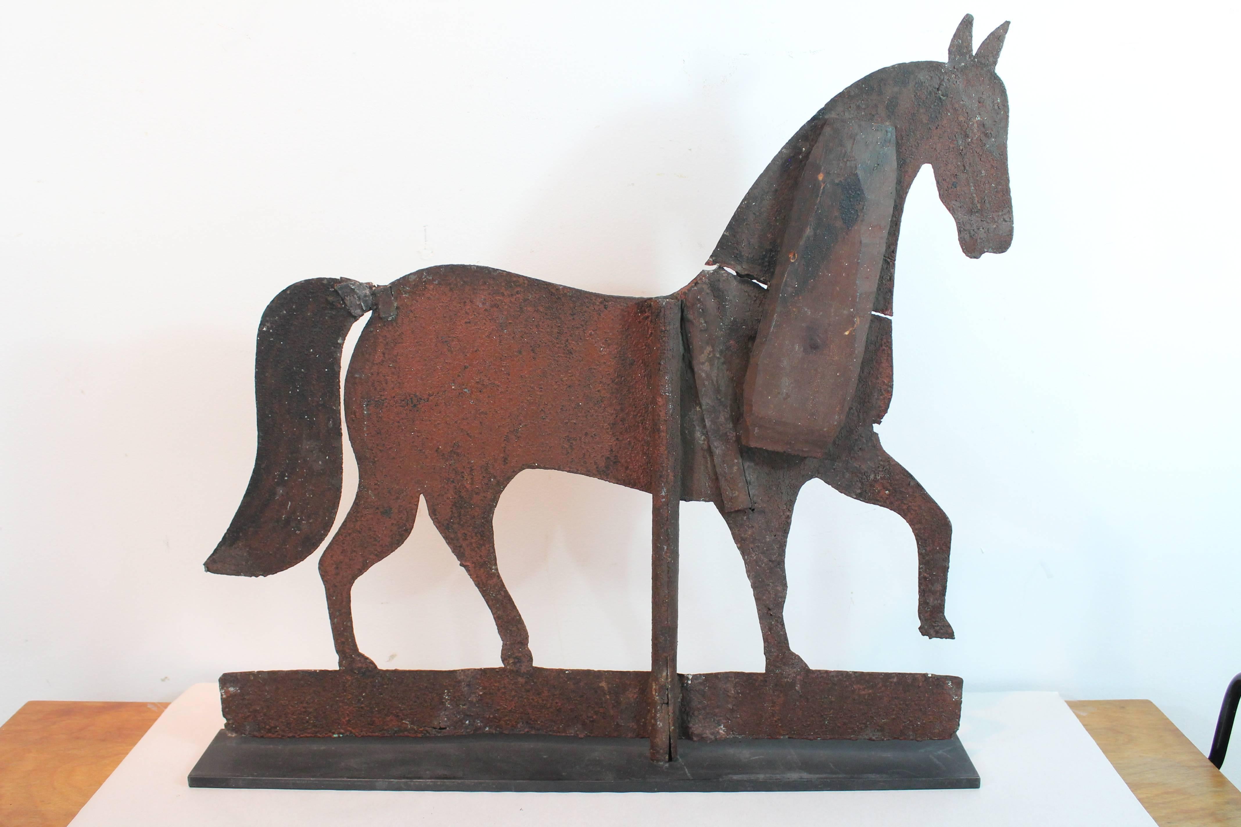 Great graphic Folk Art sheet metal horse Silhouette weathervane with great early wood neck repair that adds dimension and a quirky presence.
From the Harvey and Isobel Kahn collection.
Mounted on contemporary steel stand.