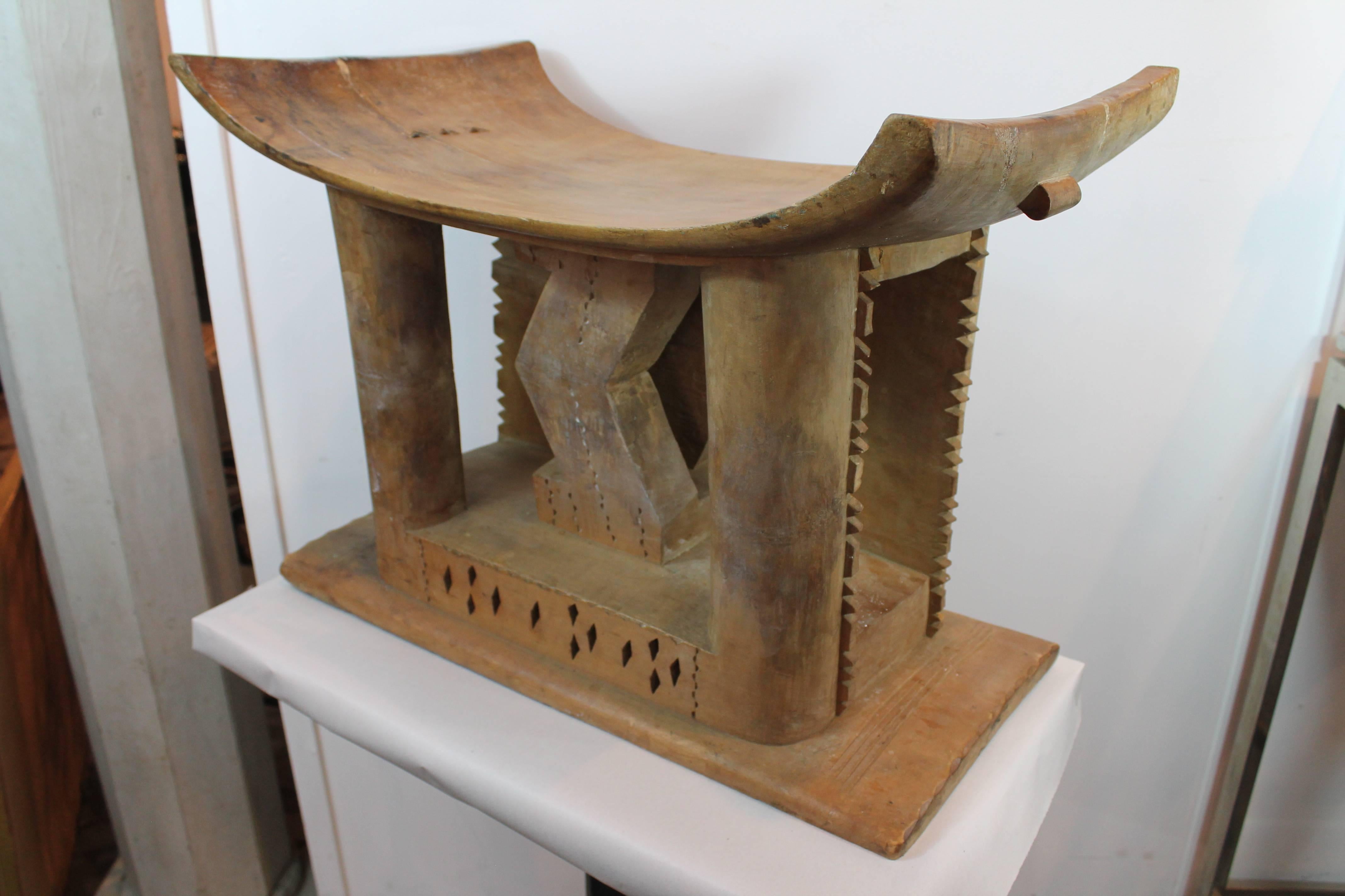 Ashanti stool from Ghana, carved from a single piece of wood.
Wonderful carved details of triangular voids and a reverse zig zag center structural design. Use as a low end table, stand or seat.