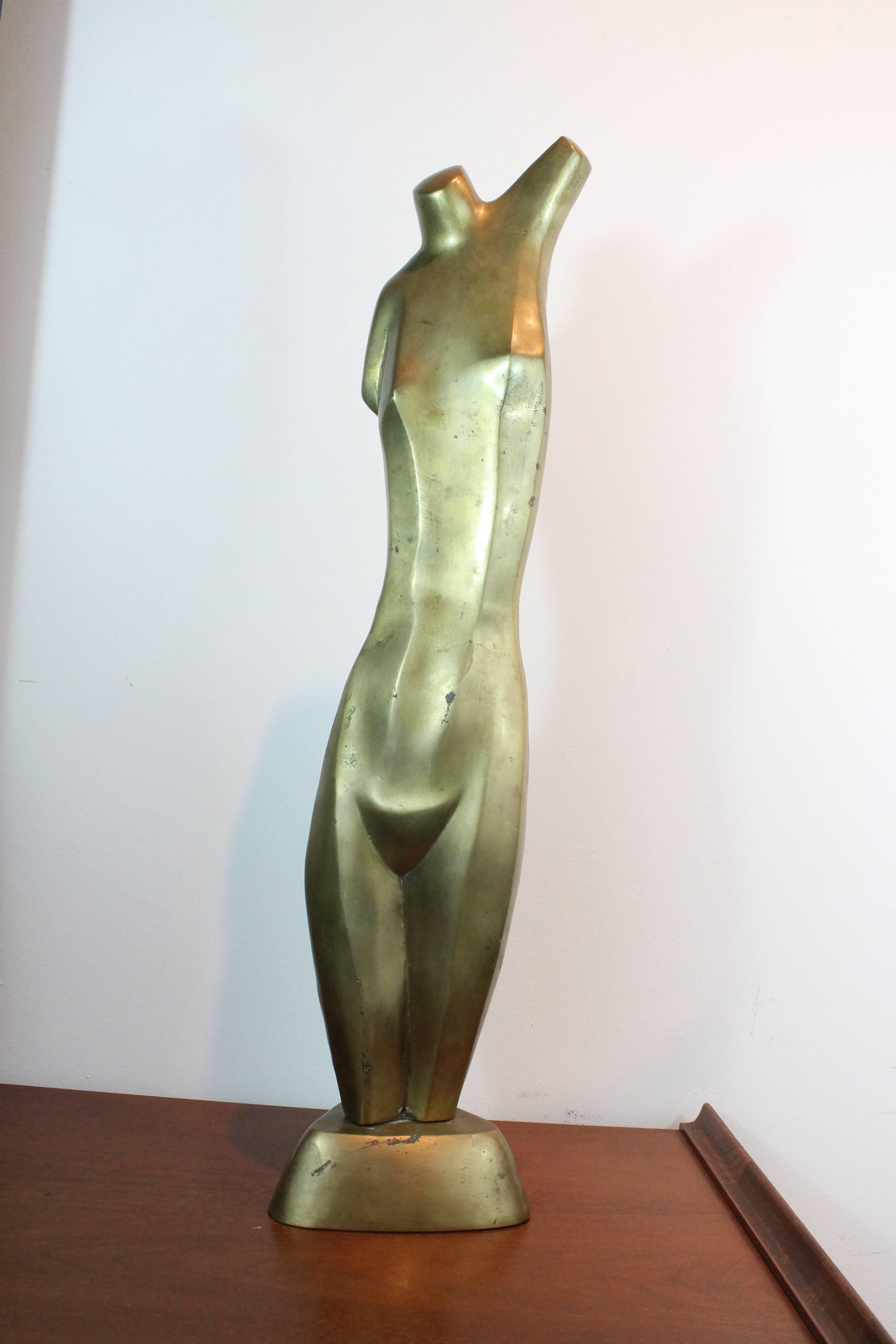 Wonderful and graceful large-scale modernist elongated female nude sculpture in brass on a triangular plinth.