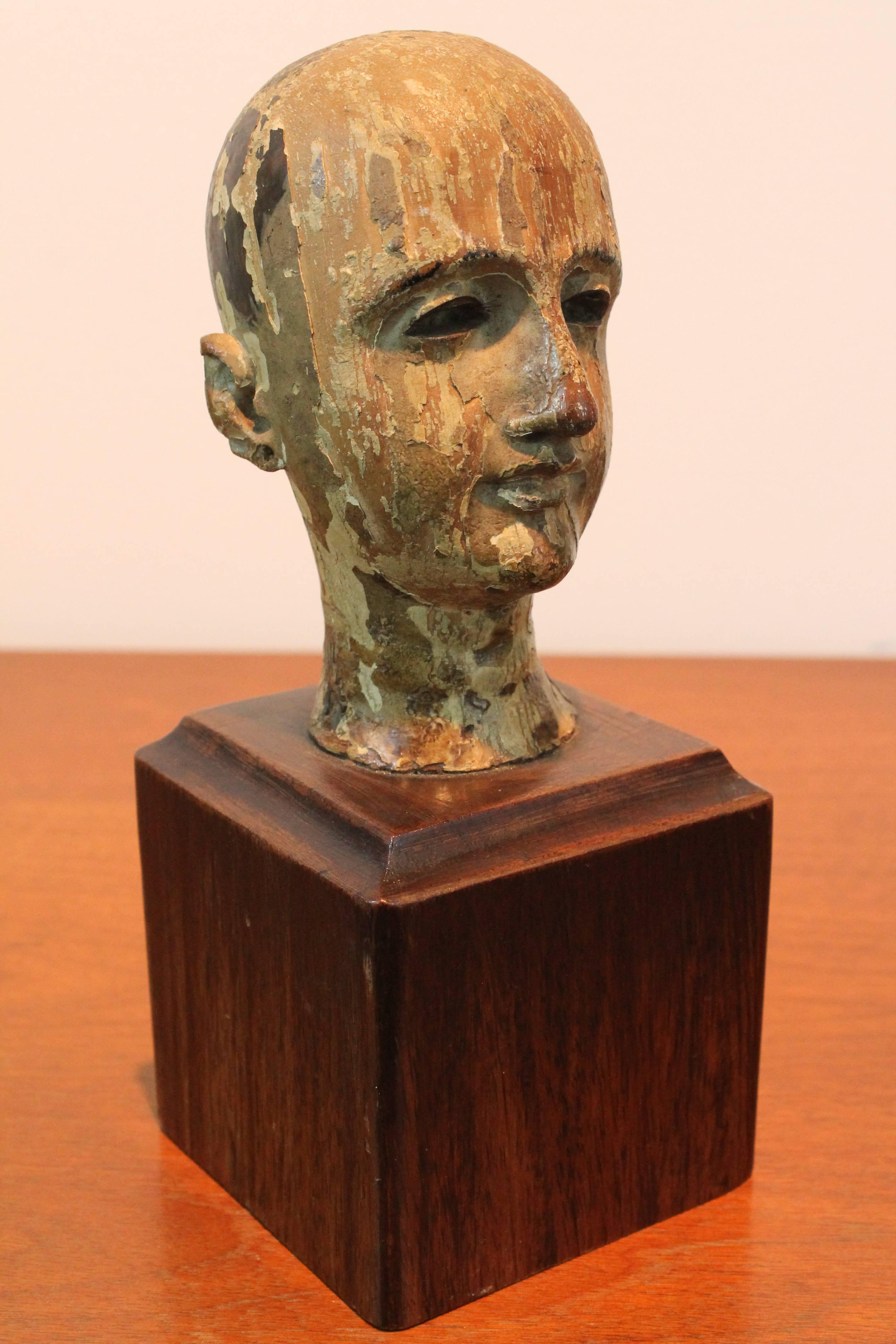 Exceptional surface and delicately detailed carving on this 19th century polychromed Santos head.
There were originally glass eyes which have long been gone, but their absence creates a haunting and powerful presence.
Mounted on a walnut plinth