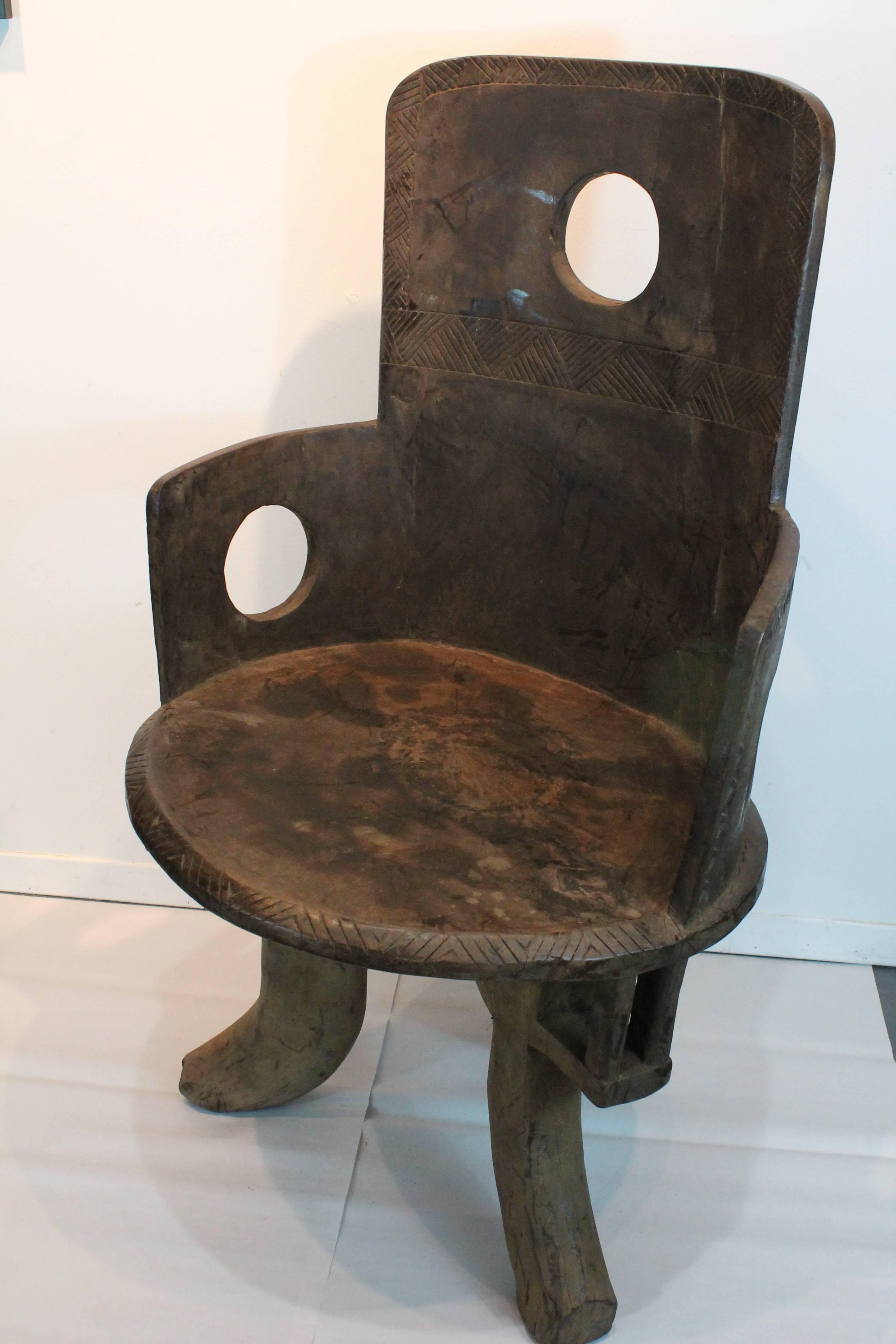 Unusual circular cutout designed Ethiopians Chief chair carved from a single piece of wood.
Fantastic carved geometric designs on the backrest, perimeter of the seat , and most prominently on the back of the chair.
Graphic sculptural presence and