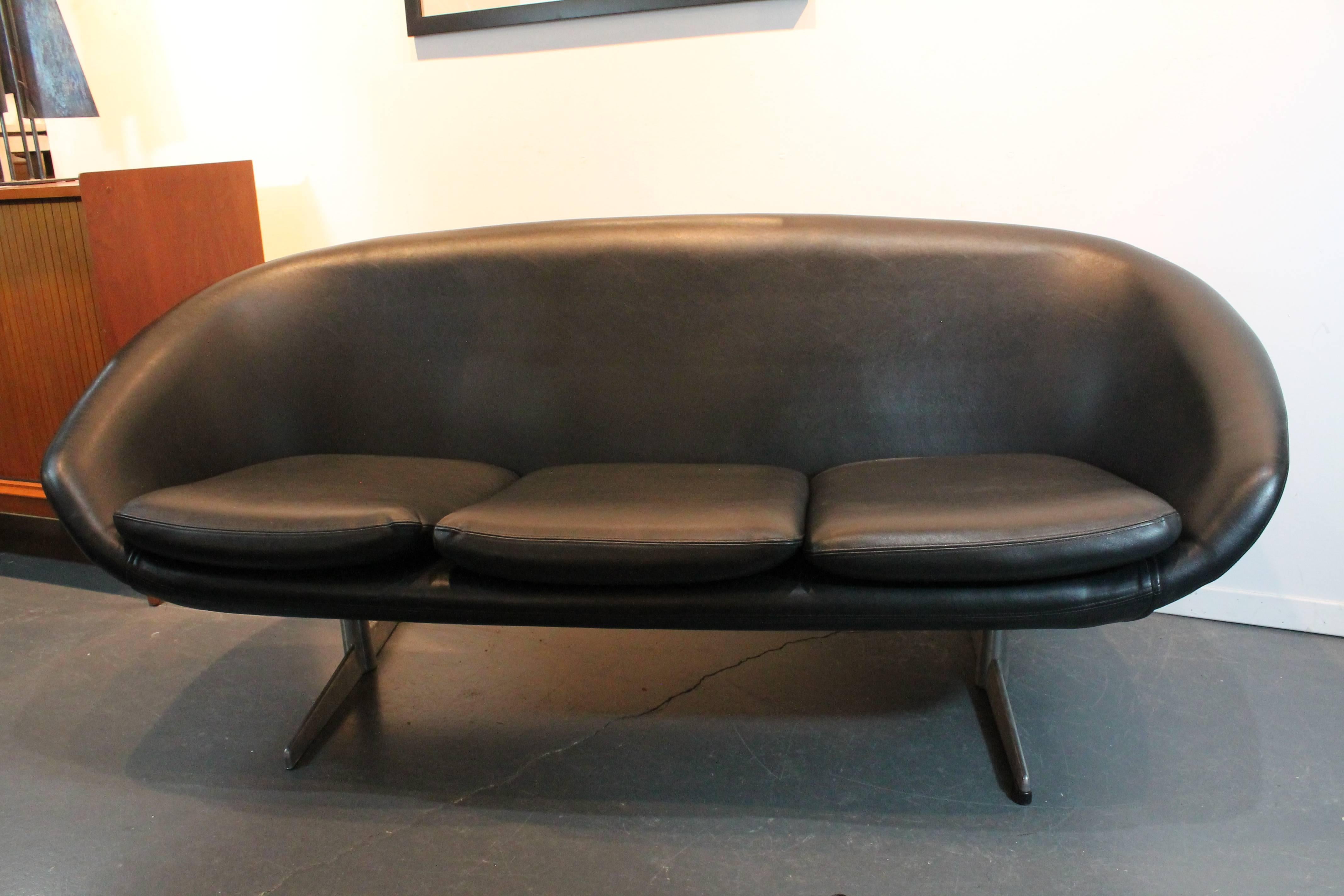 Mid - Century Modern 3 seater black vinyl and aluminum legged Overman sofa.
