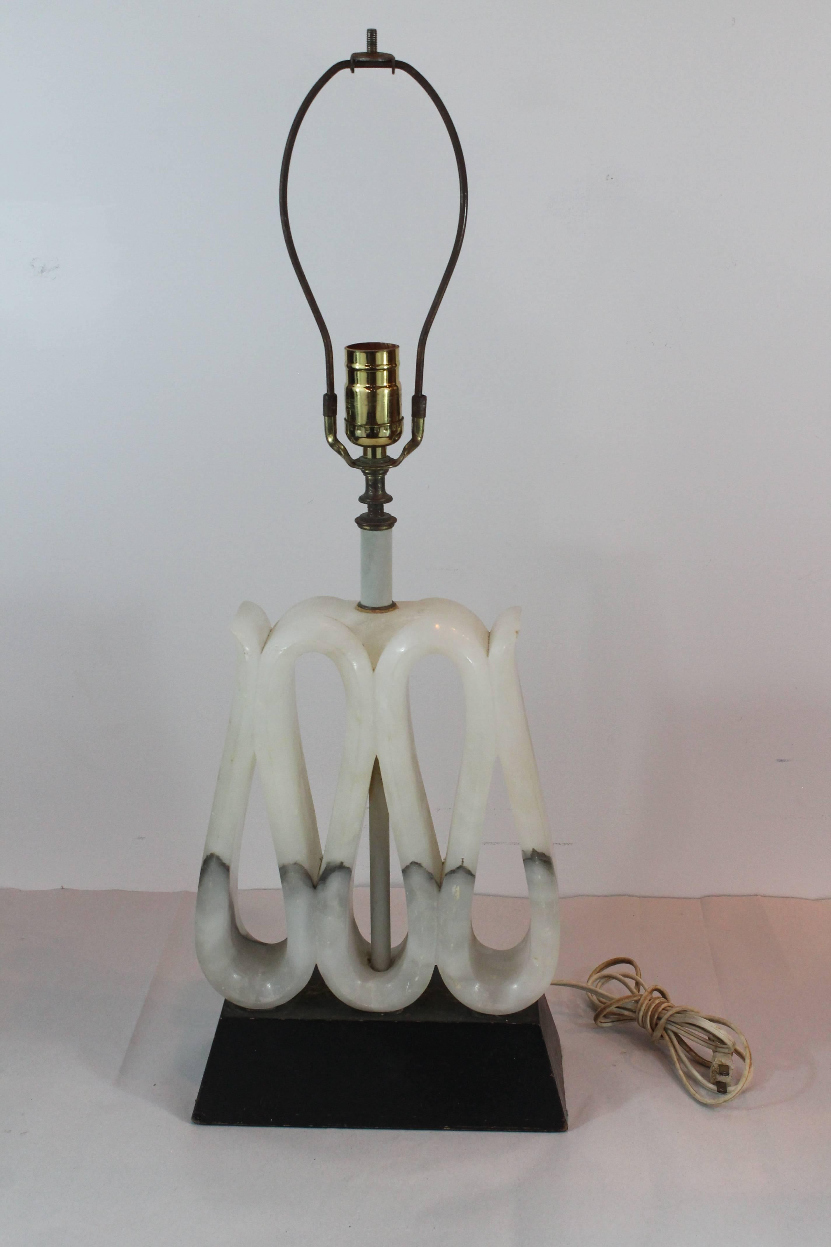 Exceptional modernist form on this carved alabaster ribbon lamp set upon an ebonized plinth.
The shade is not included.