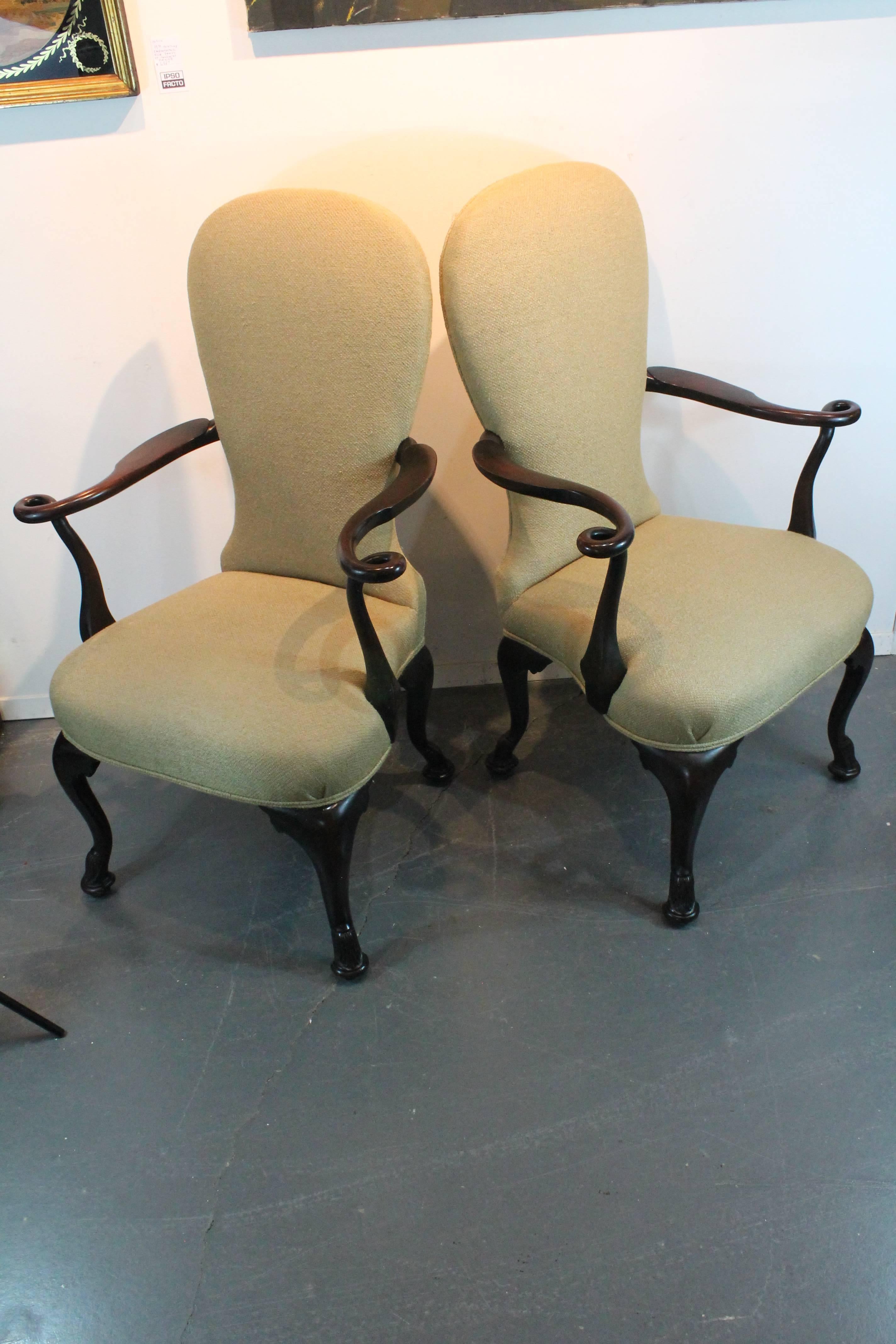 Incredible carved arms that form a loop with the grace of a ribbon captured in motion on this pair of 19th century Irish armchairs.
Wonderful dancing sinuous lines throughout these chairs.
Exceptional carved hoof like details in the feet as