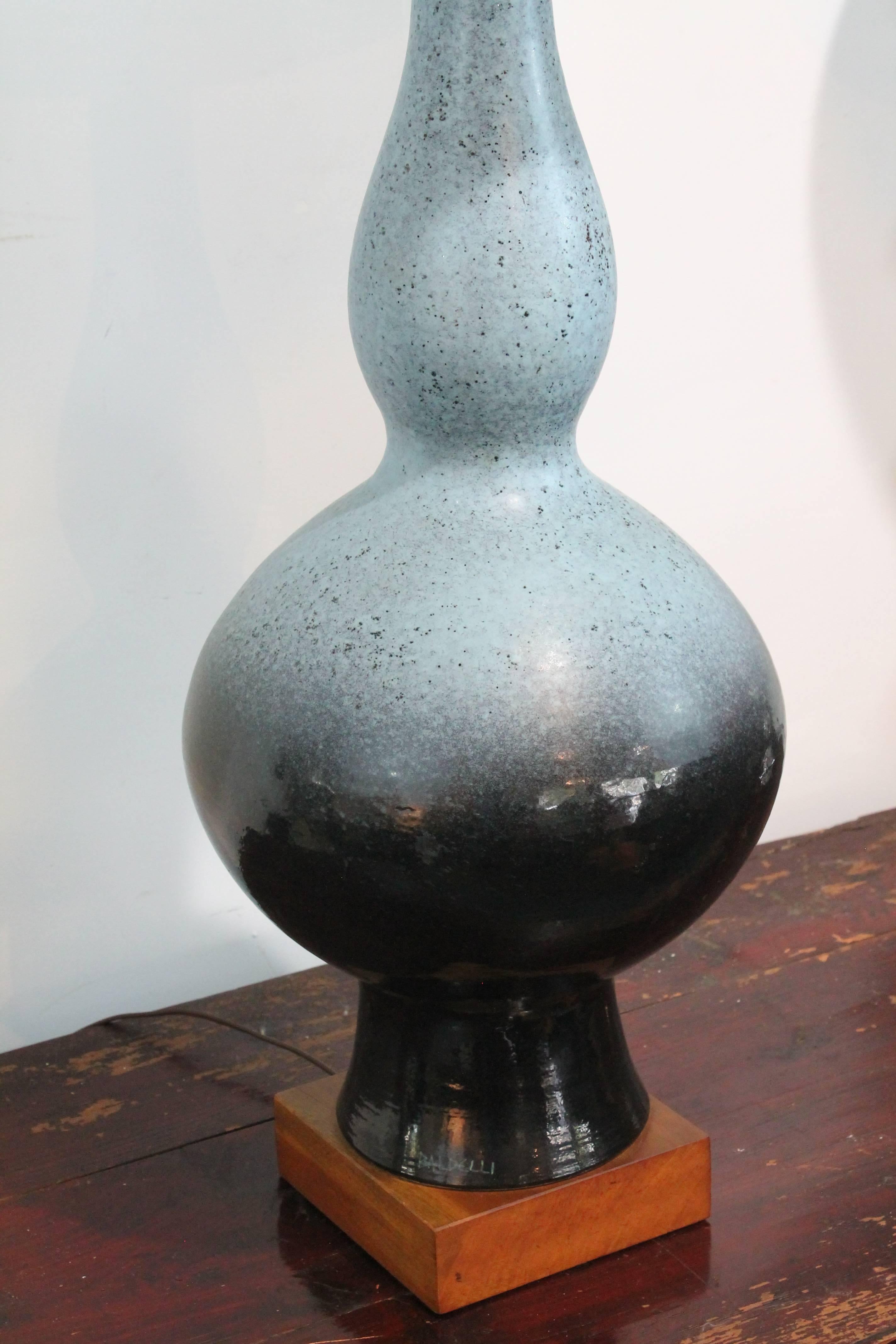 Large scale Italian ceramic lamp with exceptional two-toned glaze signed Baldelli on the base.
Set on a wooden plinth with original shade.
 